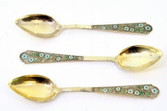 Set of three teaspoons in gilded silver with pearl handles and enameled flowers