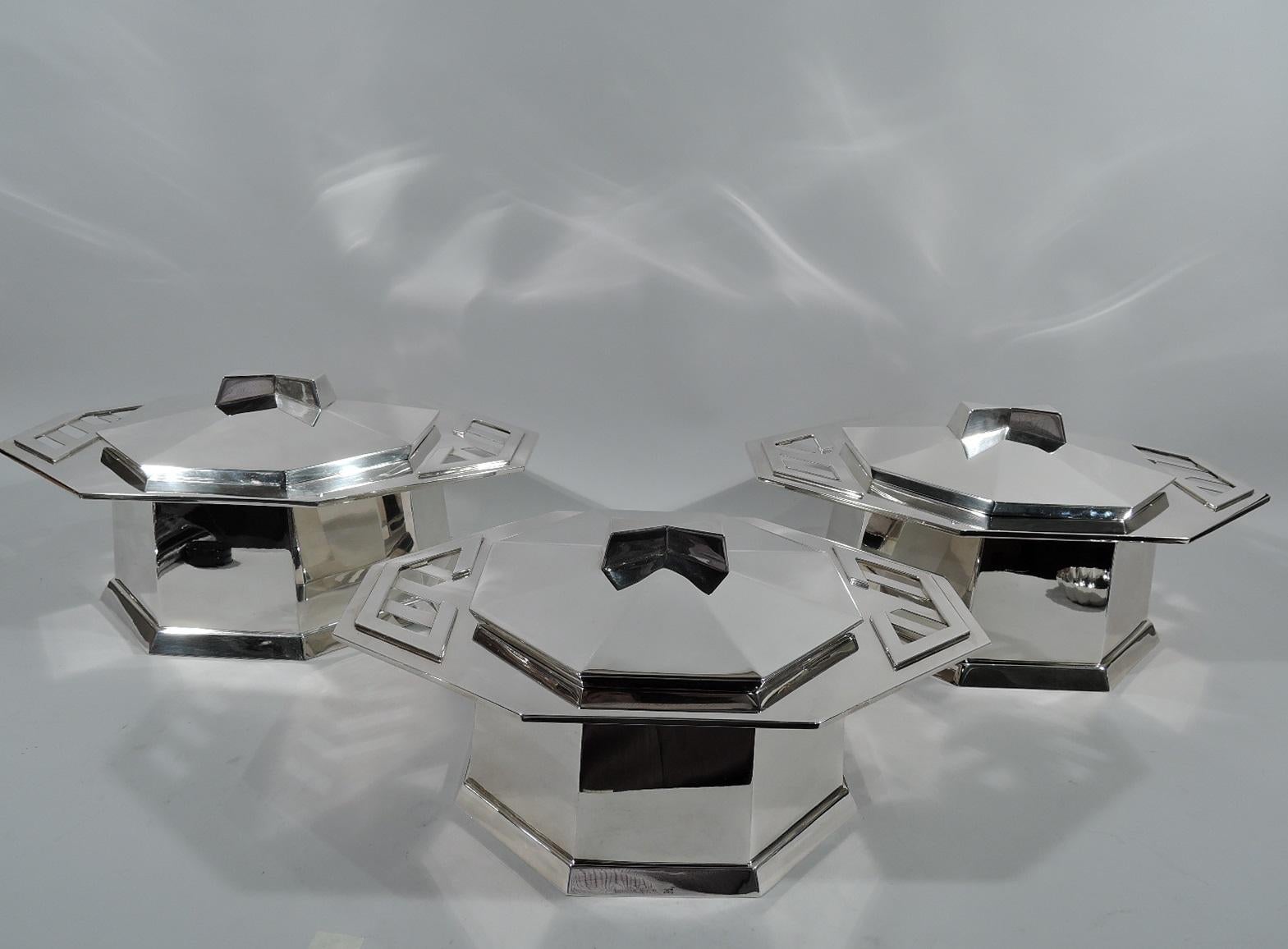 Set of three sterling silver covered tureens after a design by Frank Lloyd Wright. Retailed by Tiffany & Co. in New York. This set comprises 1 small and 2 large tureens. Each: Octagonal bowl and wide and overhanging rim with applied and cutout