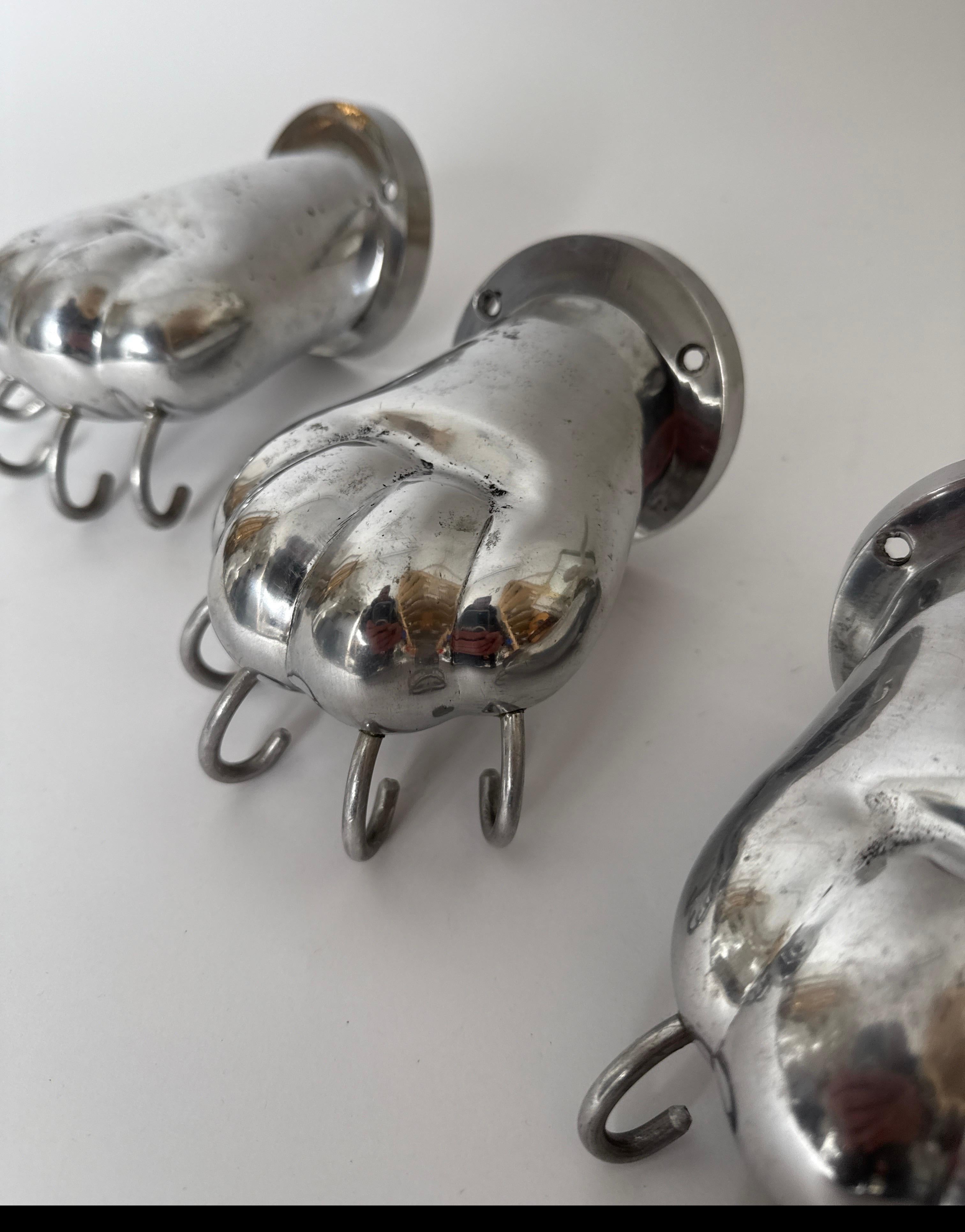 Cast Set of three Towel Holders in the shape of Lion Paws made of Polished Aluminum For Sale