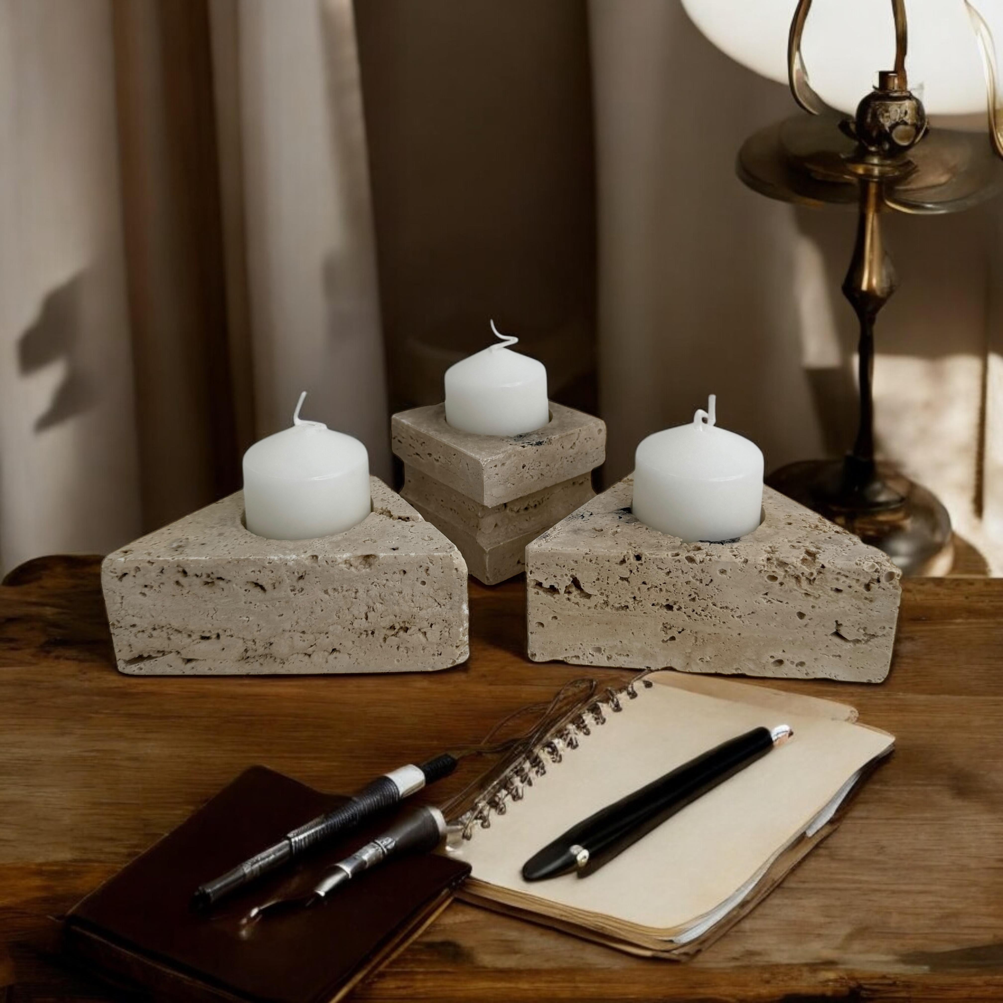 This beautiful set of Candlesticks in Travertine Marble is a wonderful example of Italian decorative objects production during the 1970s. Made by Fratelli Mannelli, the color and the texture of the marble, together with the pure and geometrical