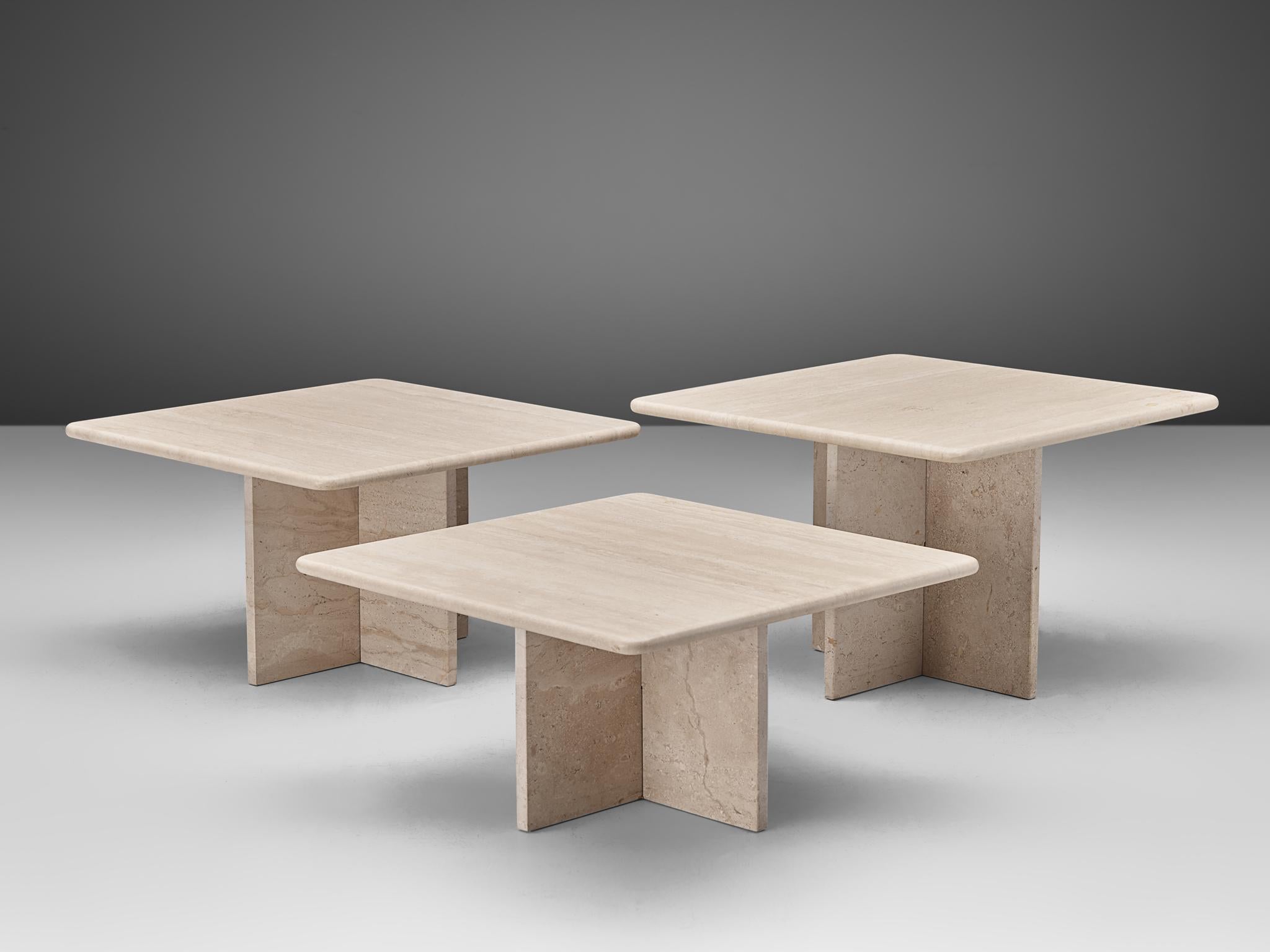 Set of three coffee tables, travertine, Italy, 1970s.

These strong coffee tables each feature one big foot and a cross travertine tabletop. The aesthetics are archetypical for postmodern design, bearing references to architectural forms and