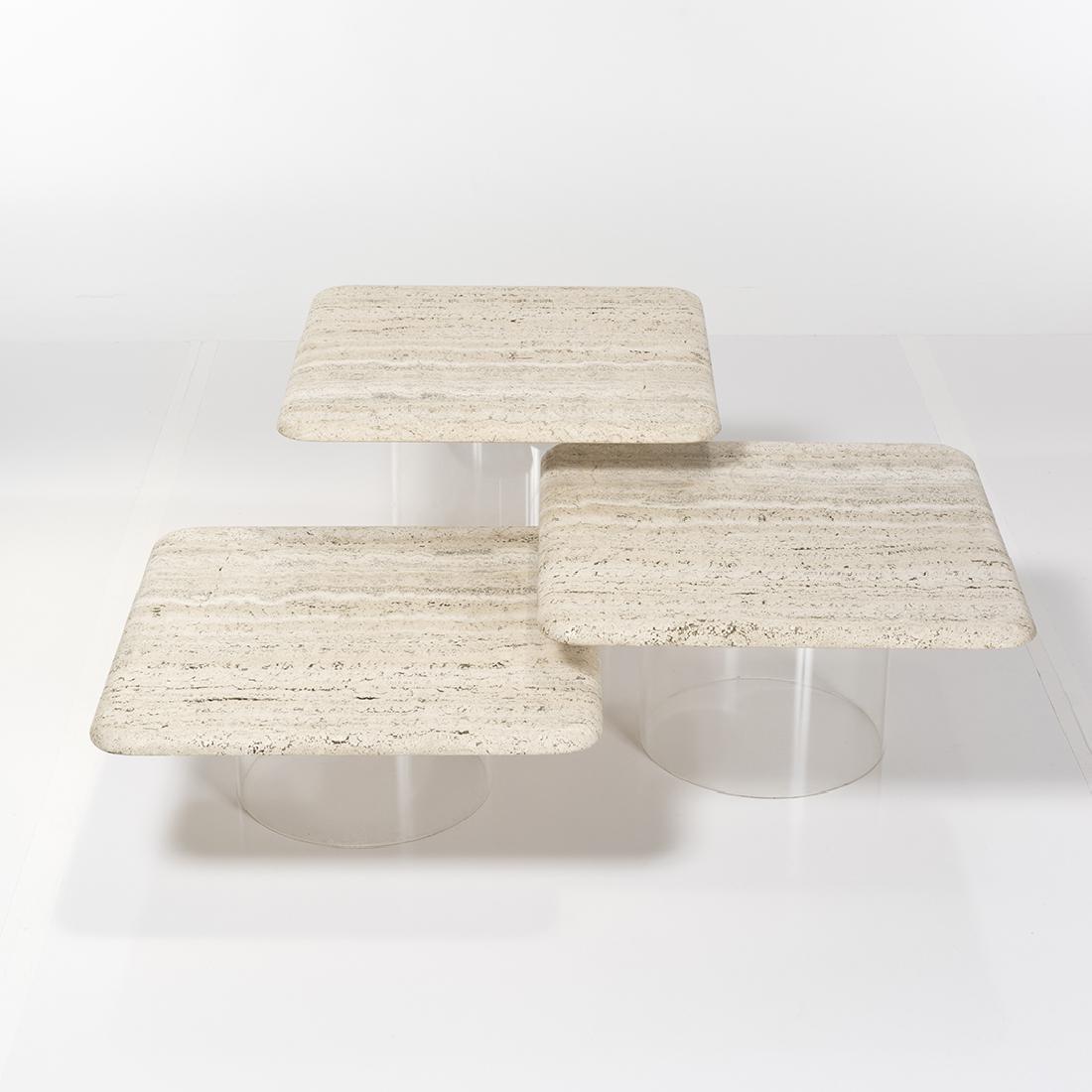 A gorgeous set of three (3) nesting tables made with cylindrical Lucite bases topped by natural travertine squares with soft curved edges. Each table is 22