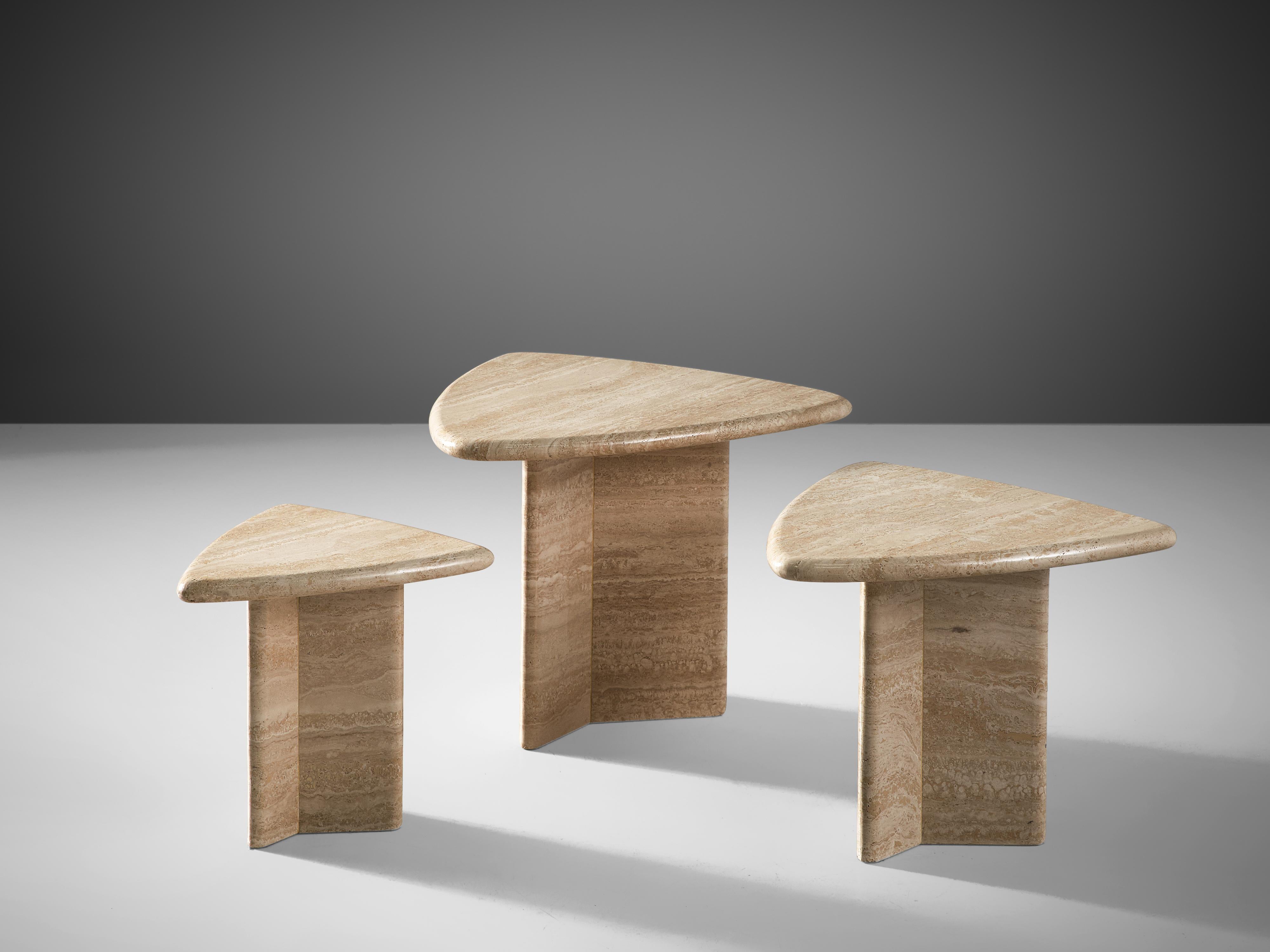 Set of three triangular travertine coffee tables, Italy, 1970.

This set of cocktail tables feature a triangular base and a triangular travertine tabletop. The circular tables have no joints or clamps and is architectural in its structure. The