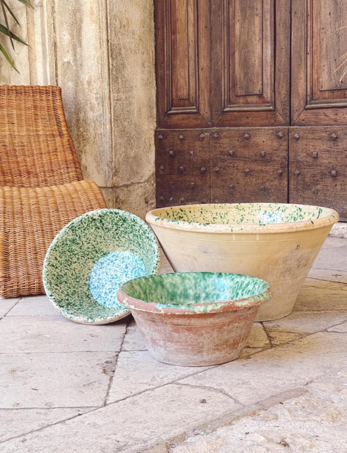 Set of Three Tuscan bowls made in the early 1900s. Each are glazed with green and white speckles on the inside, leaving the external terracotta on display.  These bowls had a variety of uses in the cucina, from making passata to holding grains and