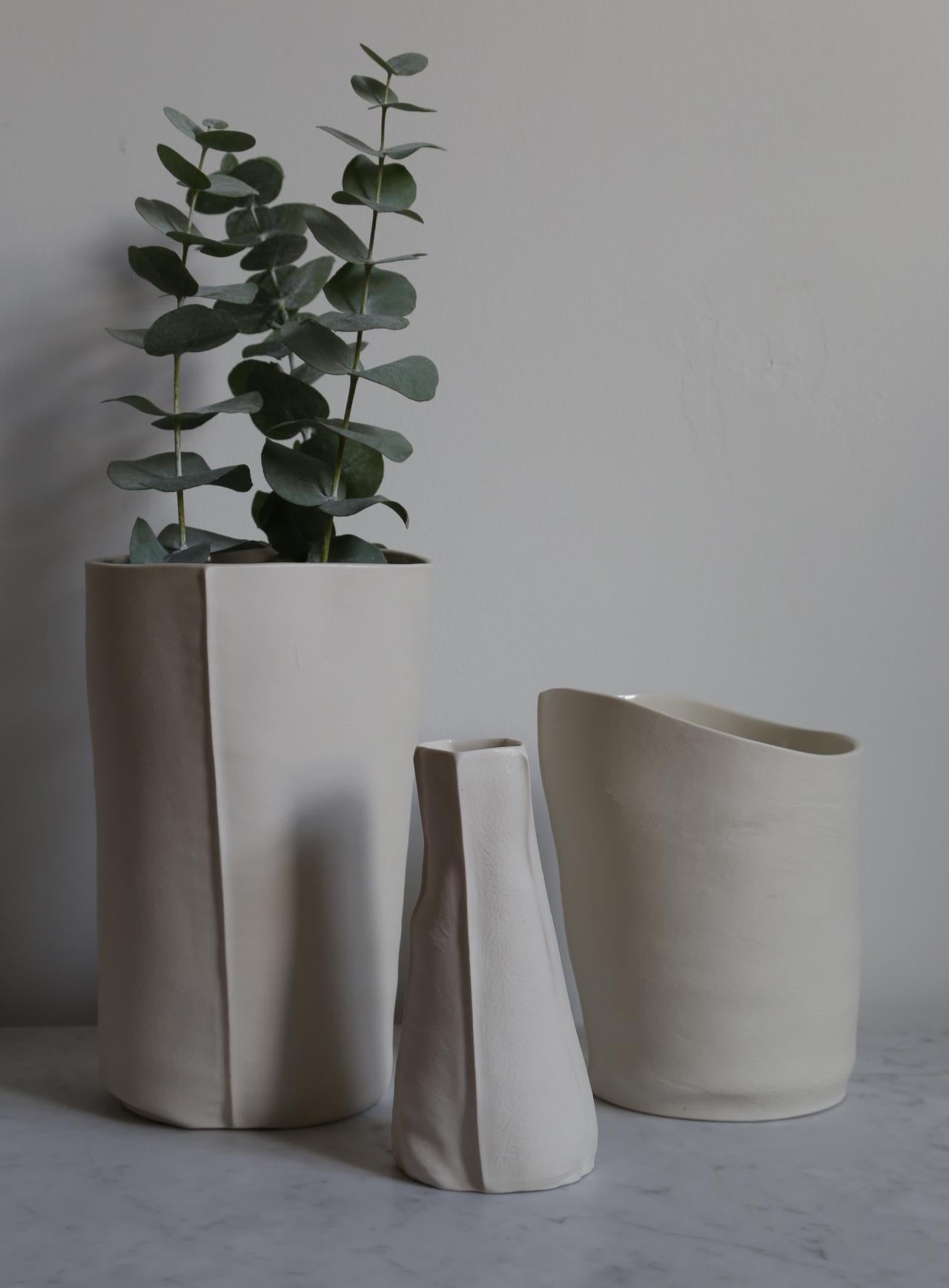 This listing is for a set of three unusual vases and vessels from the Kawa Porcelain series designed/made by Souda's Co-Owner, Luft Tanaka. These pieces are all unique. 

Each piece has been made by casting liquid porcelain into a molds made