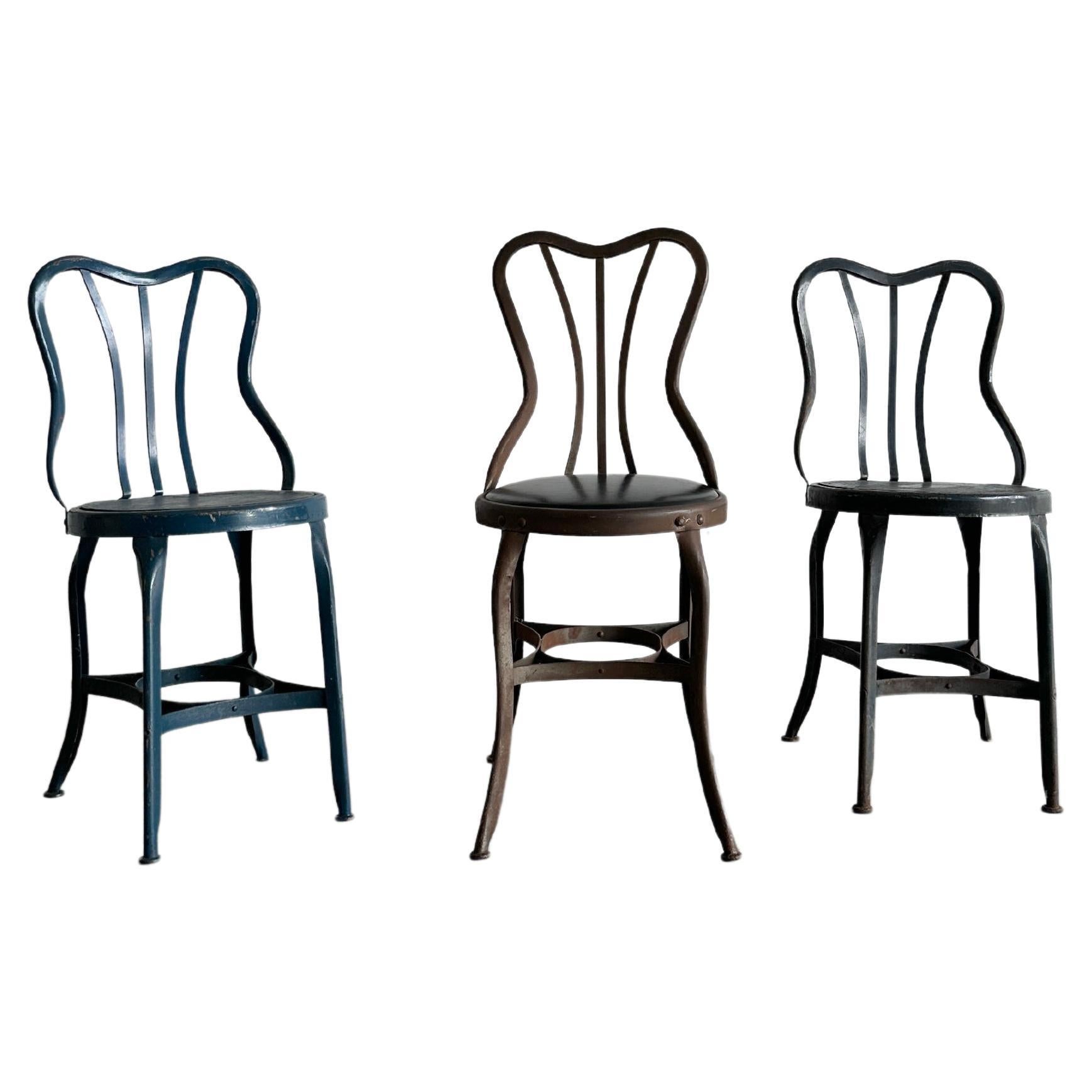 Set of three varying UHL patinated metal cafe bistro dining chairs For Sale