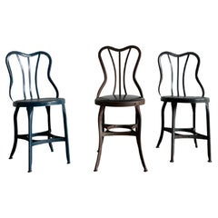 Set of three varying UHL patinated metal cafe bistro dining chairs