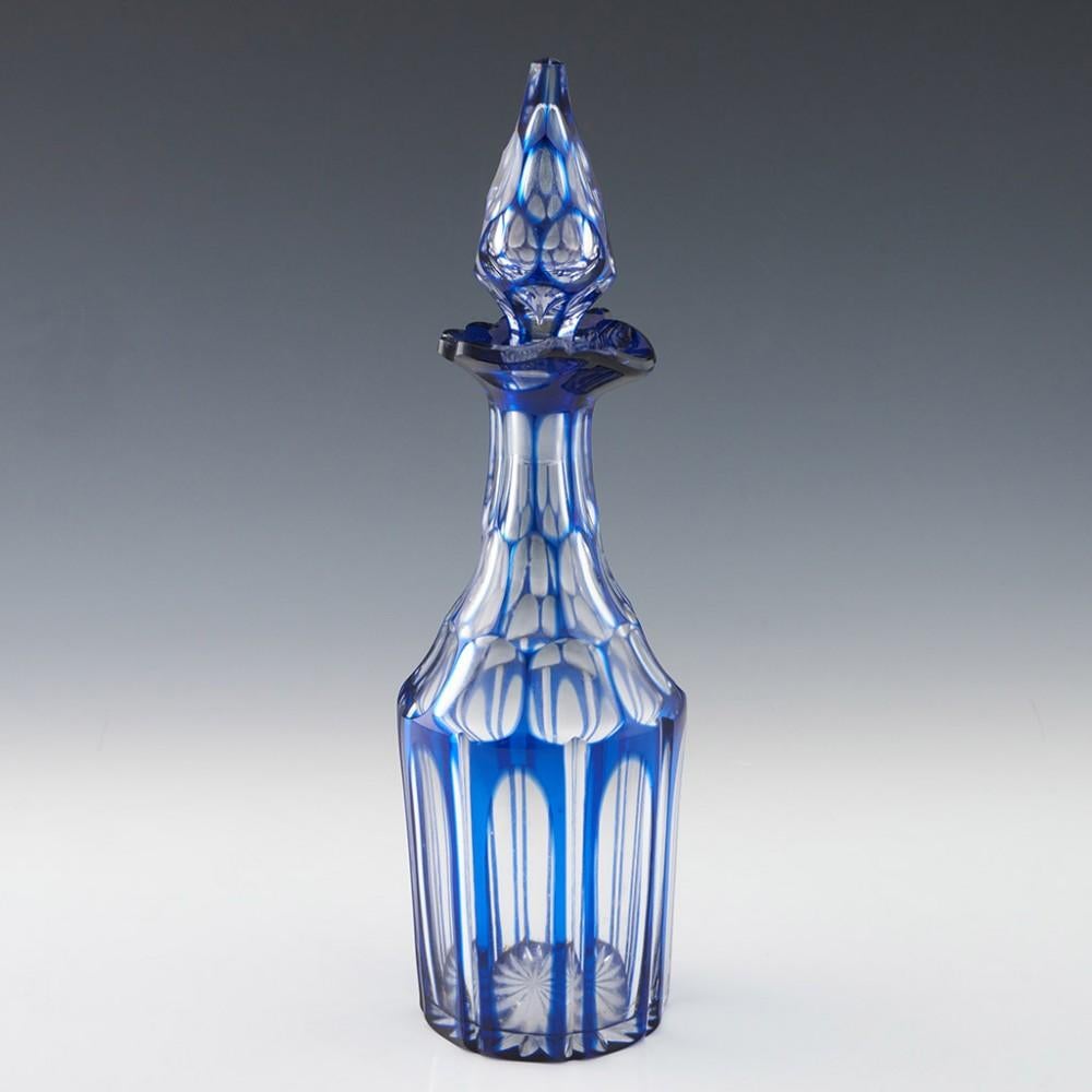 Heading : Set of three Victorian gothic revival decanters
Date : c1850
Period : Victoria
Origin : England
Colour : Blue flashed and cut to clear
Stopper : Faceted gothic spire
Neck : Slice cut
Body : Slice cut
Base : 16-spoke star cut base
Glass