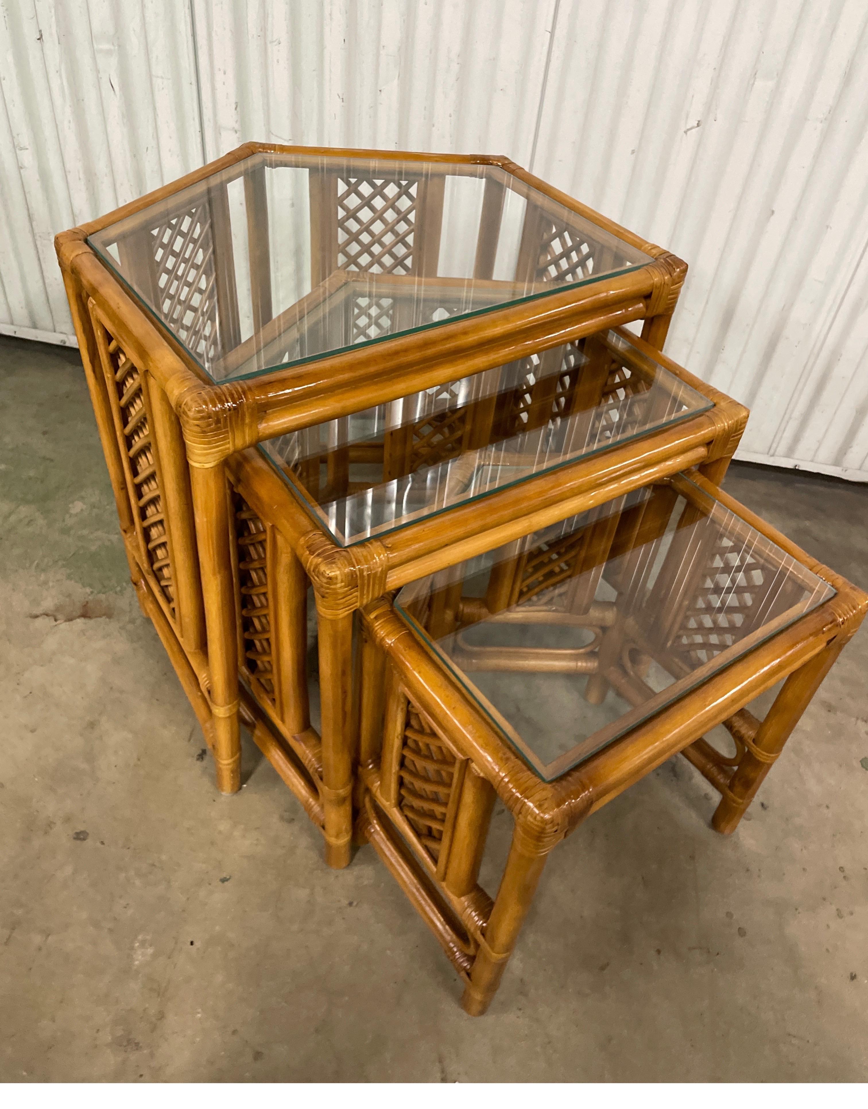 Vintage mid-century set of bamboo nesting tables with glass tops.