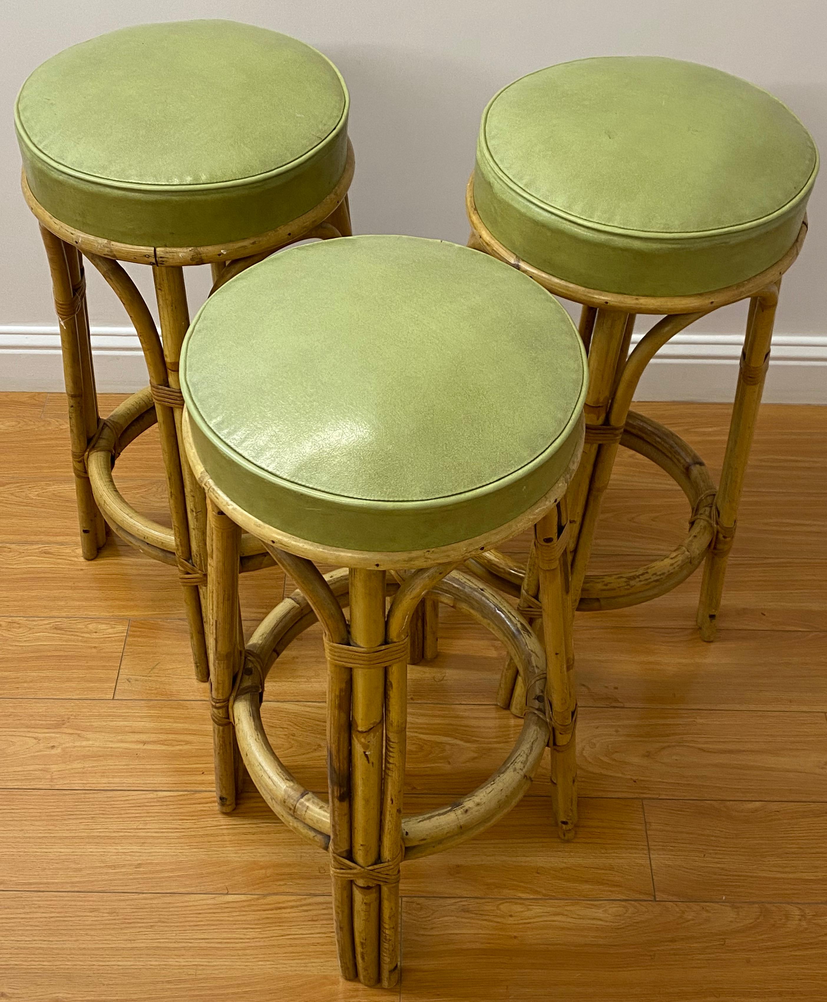 Set of three vintage bamboo & olive green leather bar stools C.1950

Handsome set of three vintage bar stools made from bamboo and covered with a nice olive green leather.

Each stool measures 18