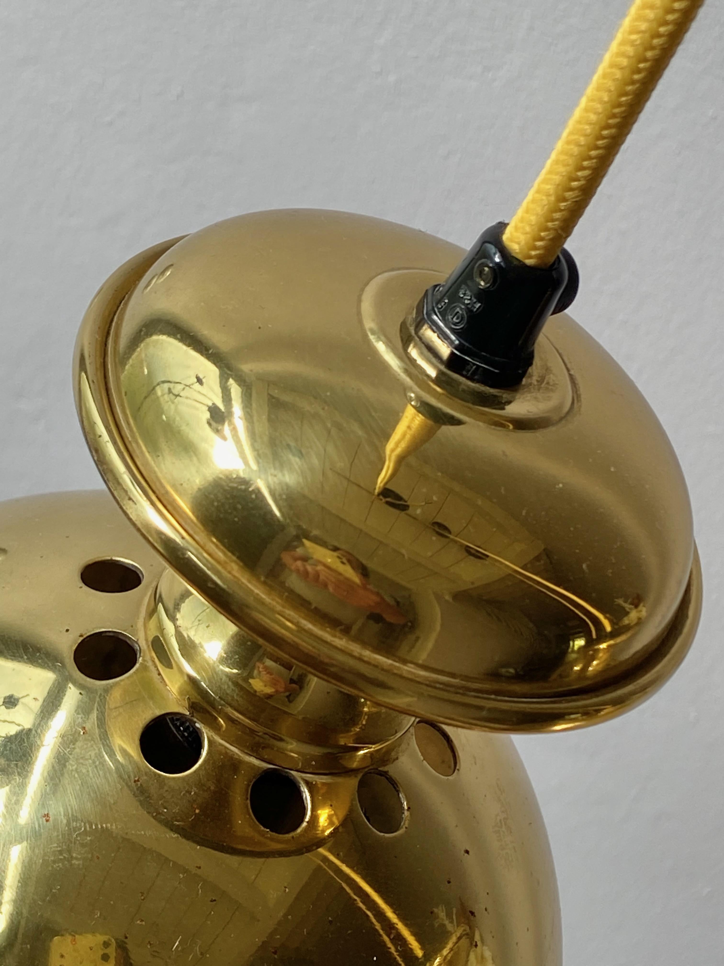 Nice set of three pendant lamps typ 'Golden Bell' design and produced by Scnadi-Lamp in 1960's, Made in Denmark. Polished brass with 1x E14 Edison screw socket in original condition. No parts missing, with new yellow fabric cord, ready to use with