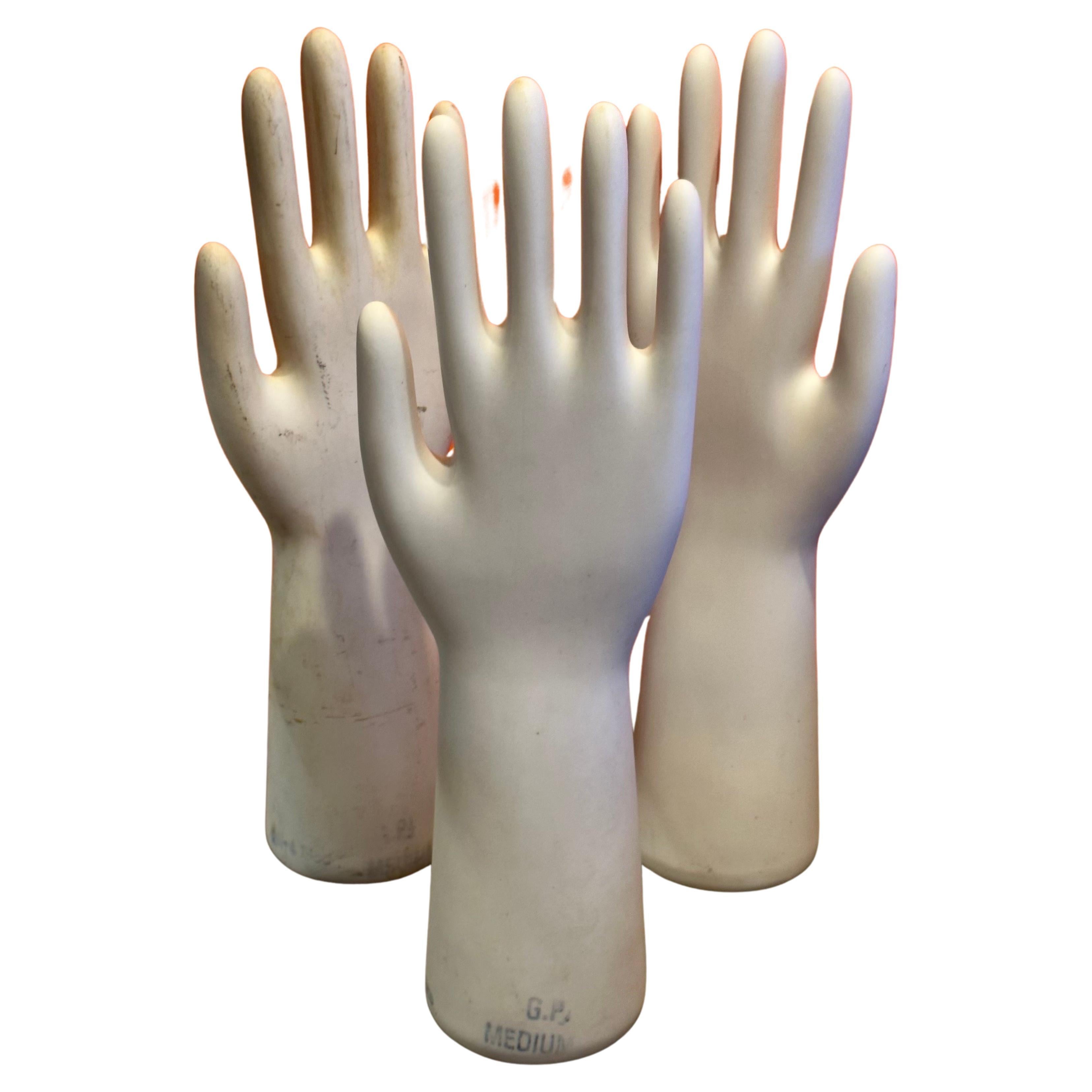 Set of three vintage industrial porcelain glove molds, circa 1980s.  The molds have a great look and make a wonderful modern sculpture.  They are in very good vintage condition with no chips or cracks and measure 4.5
