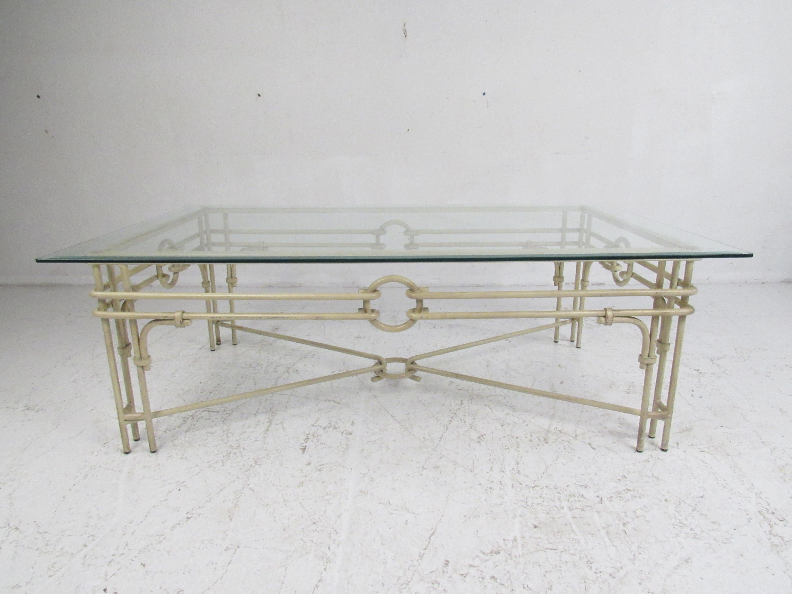 This vintage set includes one coffee table and two end tables. An unusual iron frame with 