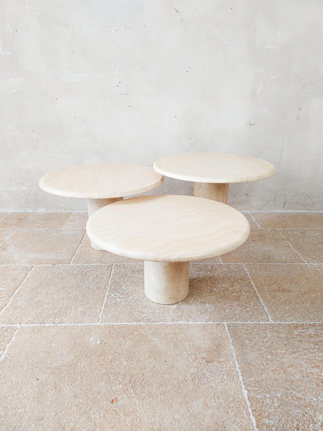 Set of three vintage Italian round travertine coffee tables, 1970s. Beautiful set of Cocktail Tables in three different heights with a round base and a round top made of travertine.

The top rests firmly on the foot (by means of a round travertine