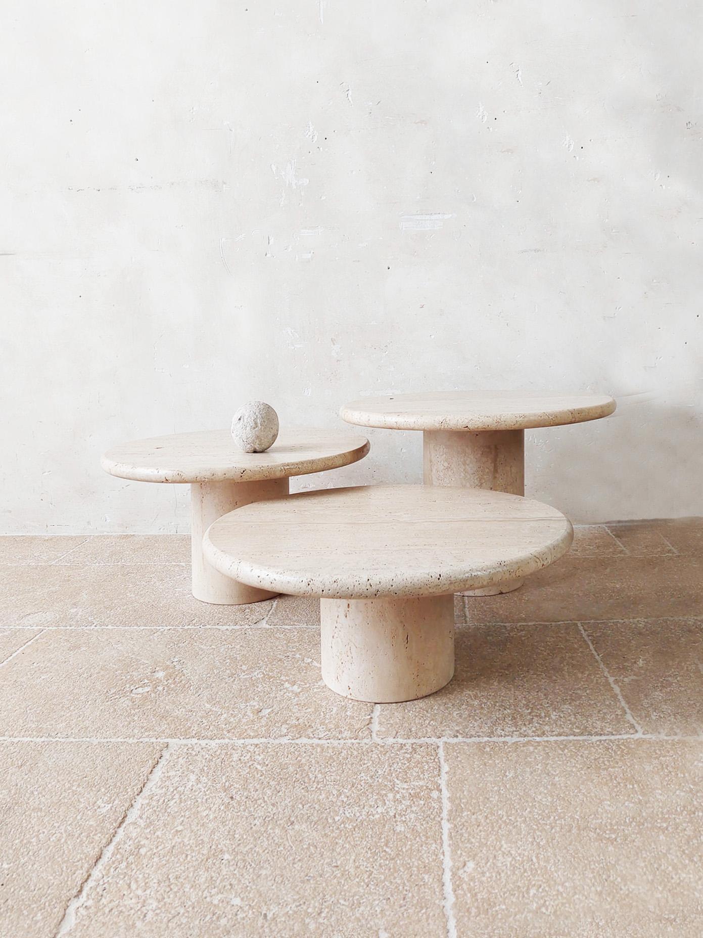 Set of three vintage Italian round travertine coffee tables, 1970s. Beautiful set of cocktail tables in three different heights with a round base and a round top made of travertine.

The top rests firmly on the foot (by means of a round travertine