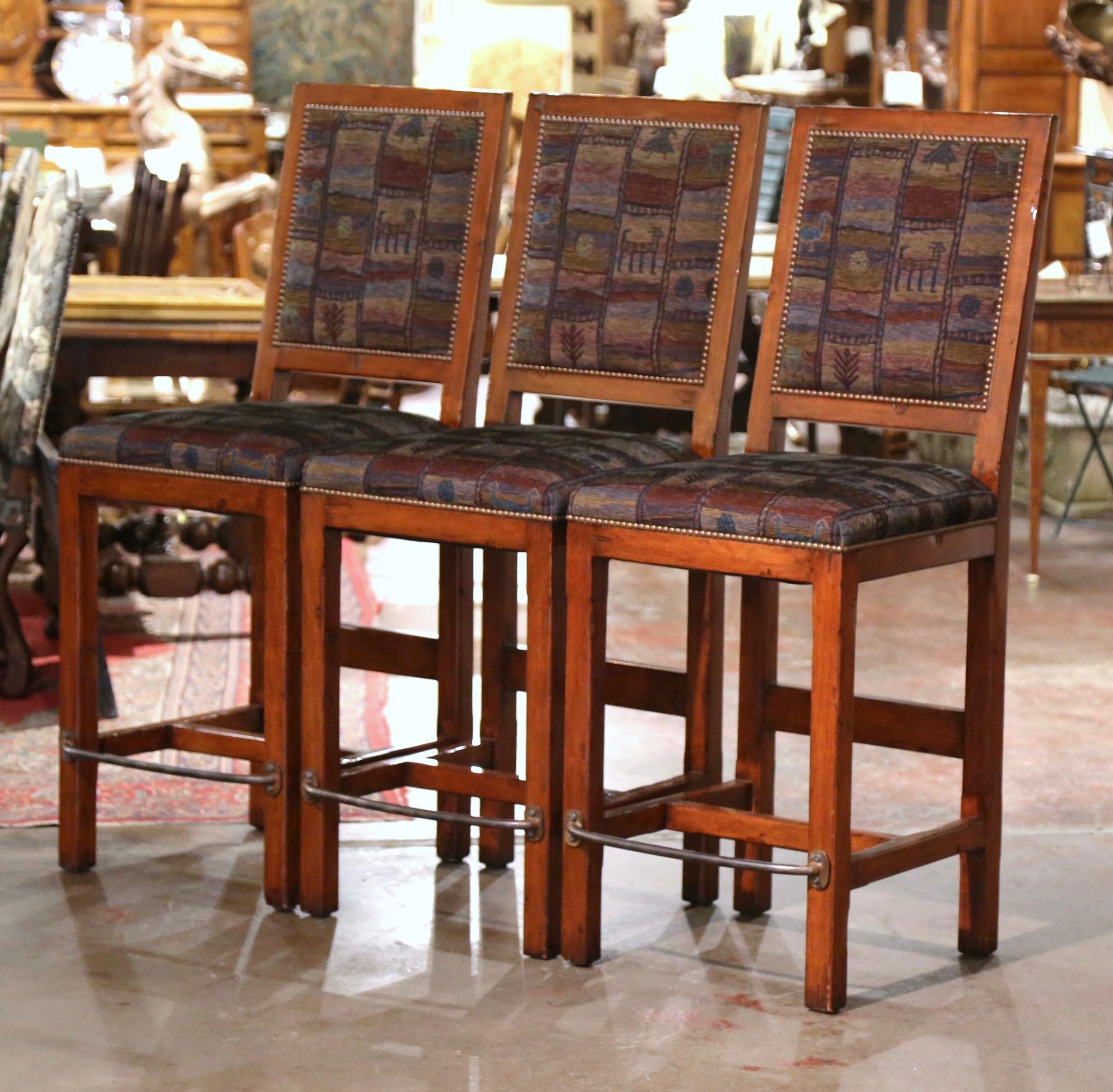 Add a Gothic look to your bar or kitchen counter with this elegant set of three vintage stools. Crafted circa 2000, the traditional barstools are the perfect height for a 42 to 45