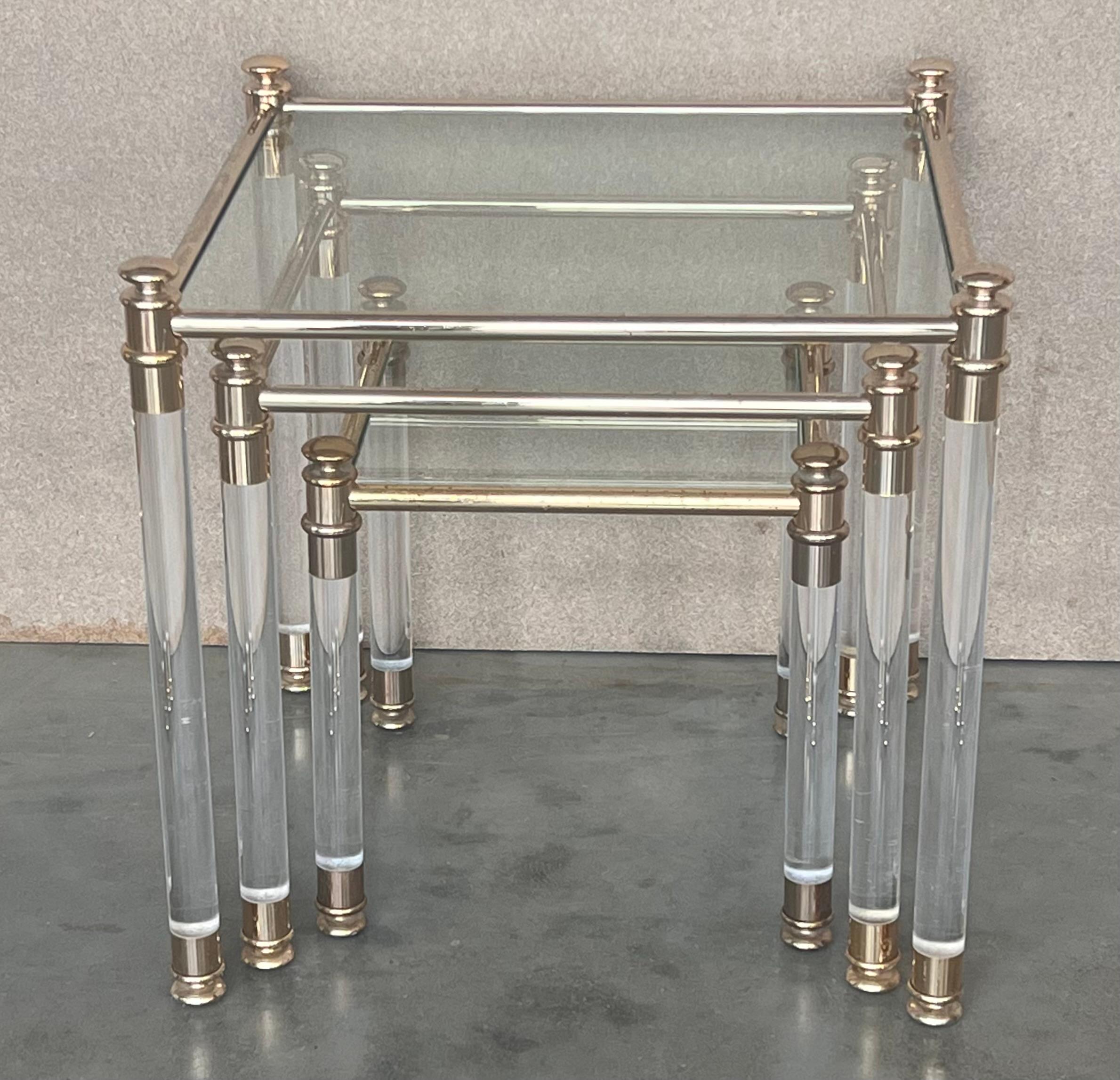 These Mid-Century Modern nesting tables embody the 1970s. They are comprised of a Lucite frame joined by golf connectors and a glass top. 

Please note that the bronze has some marks.

Measures: Small H 13.38” x W 13” x D 13”
Medium H 16.33” x W