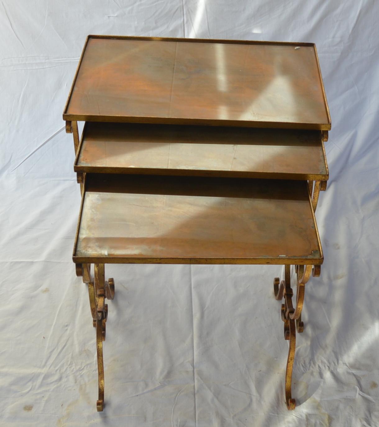 Set of three vintage nesting metal mounted tables with oxidized glass top.
Condition report: Oxidation exfoliation resulting transparent white spots in several places.
Dimensions: tabletop 55 x 36 cm, height1 - 50 cm, height2 - 48 cm, height3 - 45