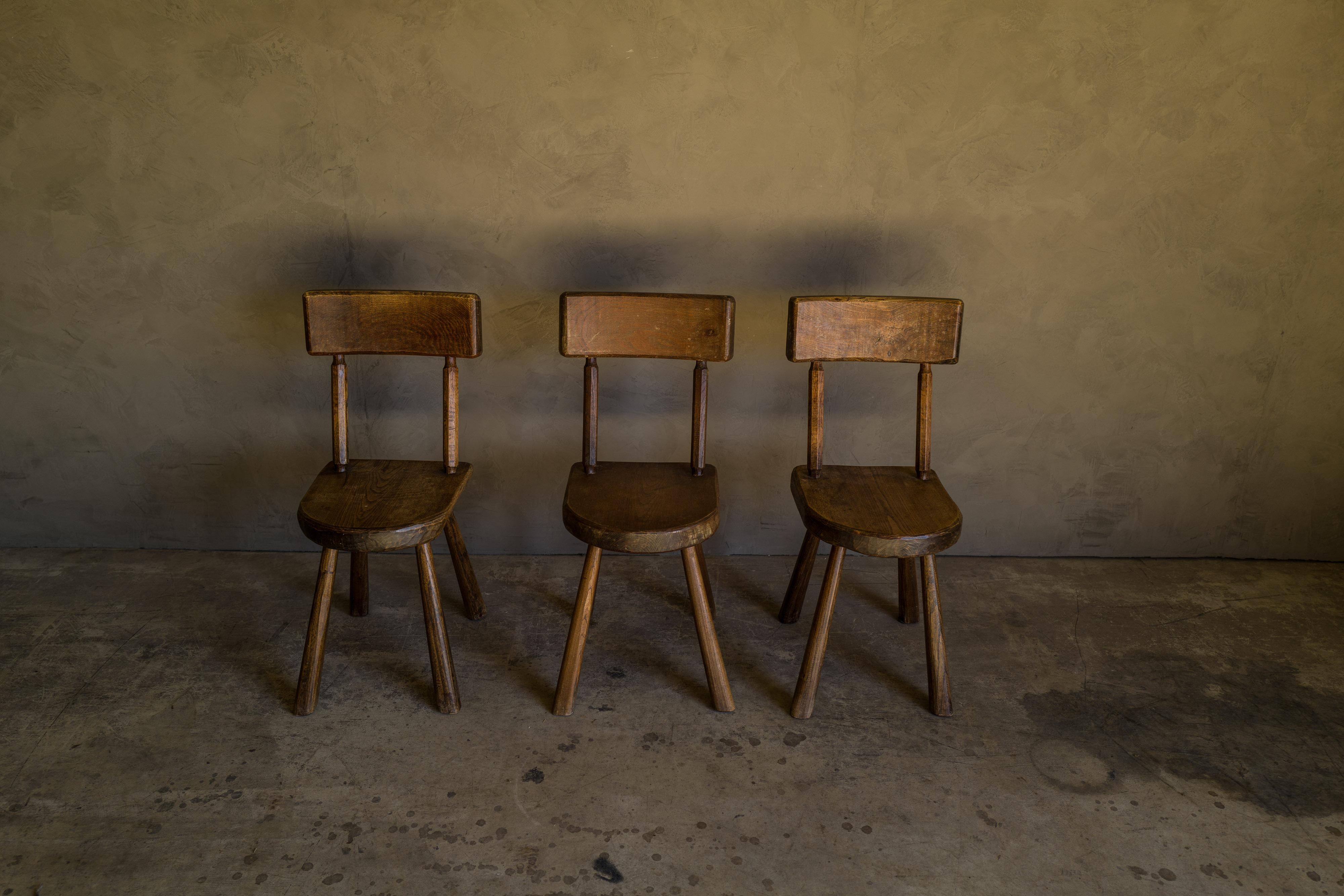 Set of three vintage oak chairs from France, circa 1950. Solid oak construction with light patina and wear.