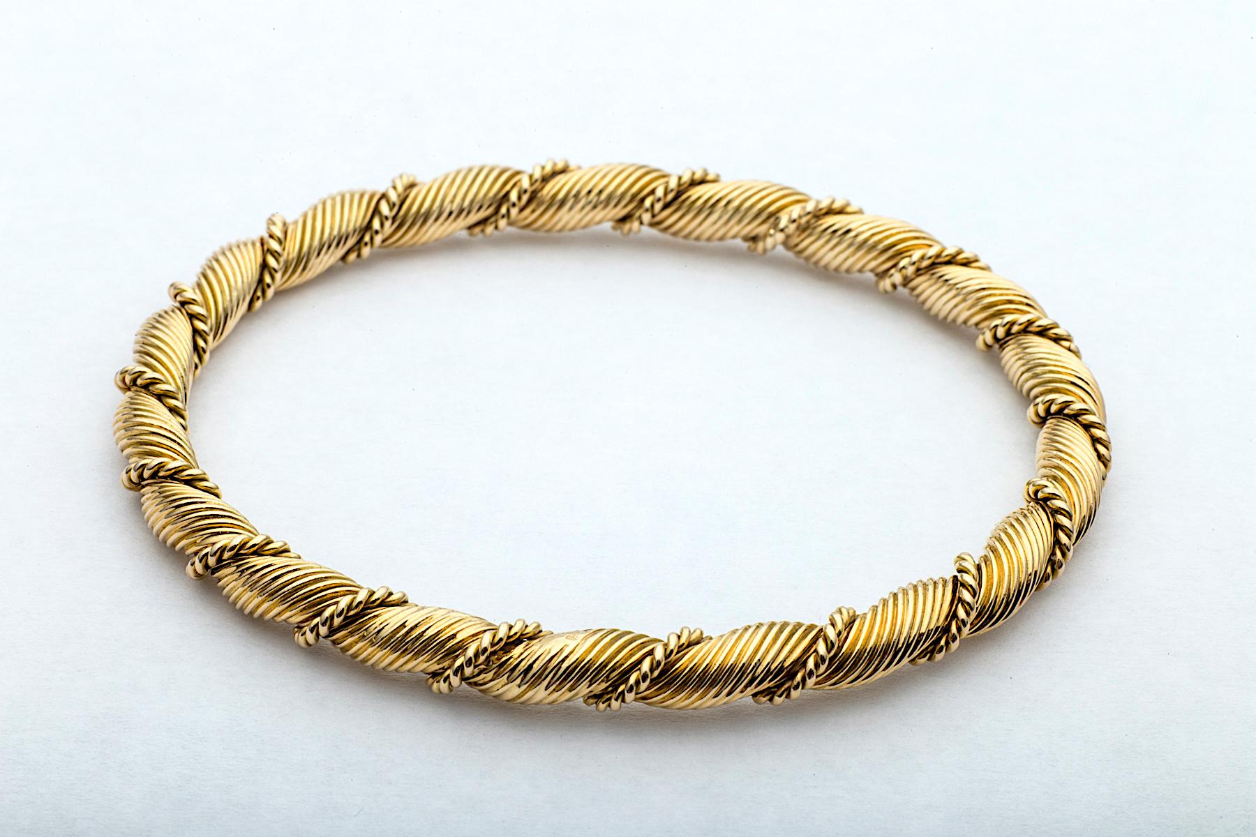You'll hit triple gold when wearing these three vintage Van Cleef & Arpels Paris 18 karat yellow gold bangle bracelets.  Created in the 1970's, with an iconic twisted rope design, these collectible bangles move with a bespoke elegance.  Stamped