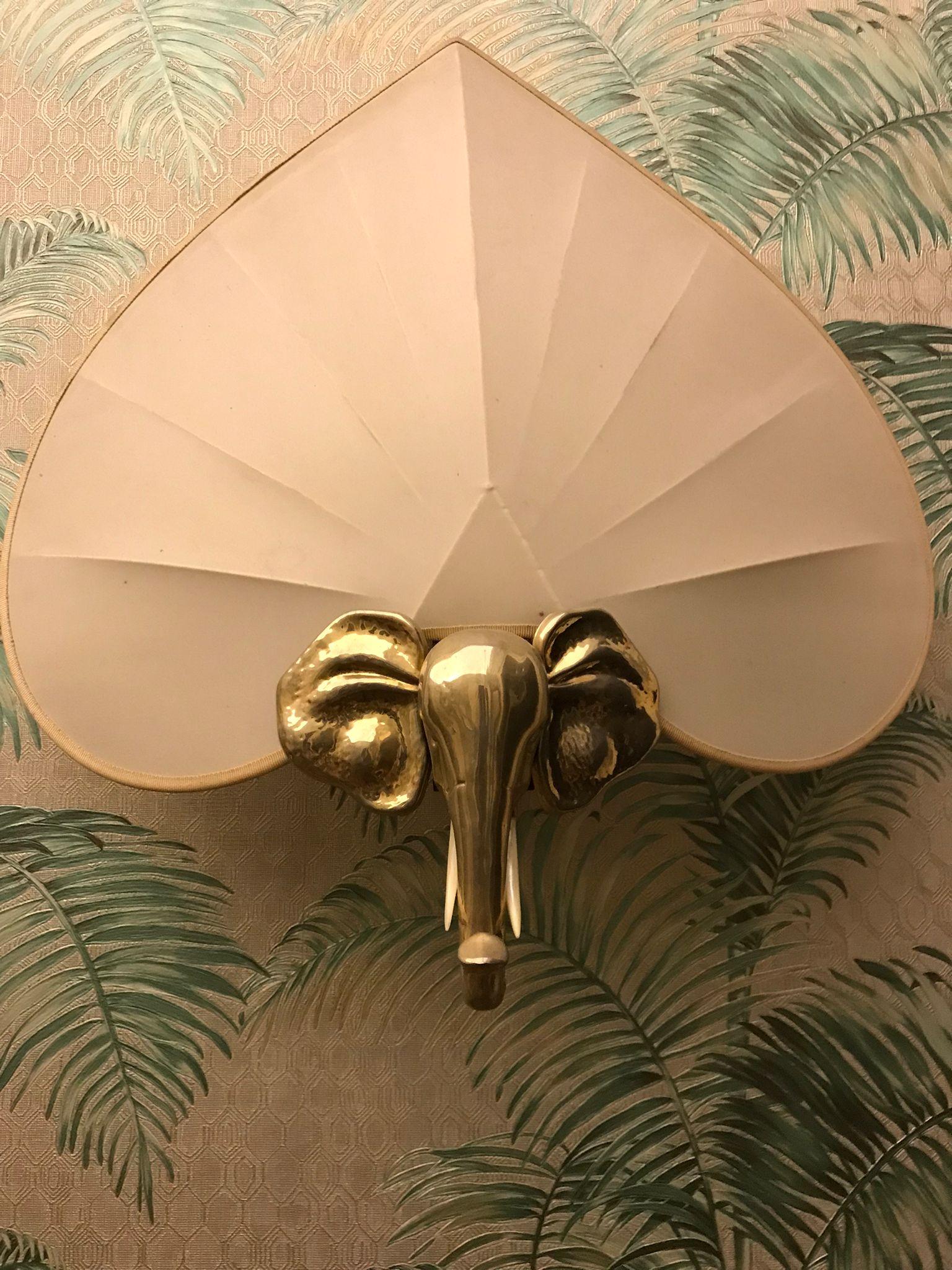 Unique set of three wall lights in silver plate in the shape of  elephant heads adorned with mother-of-pearl tasks and beautiful silk shades.
In excellent vintage condition
France, circa 1930s.