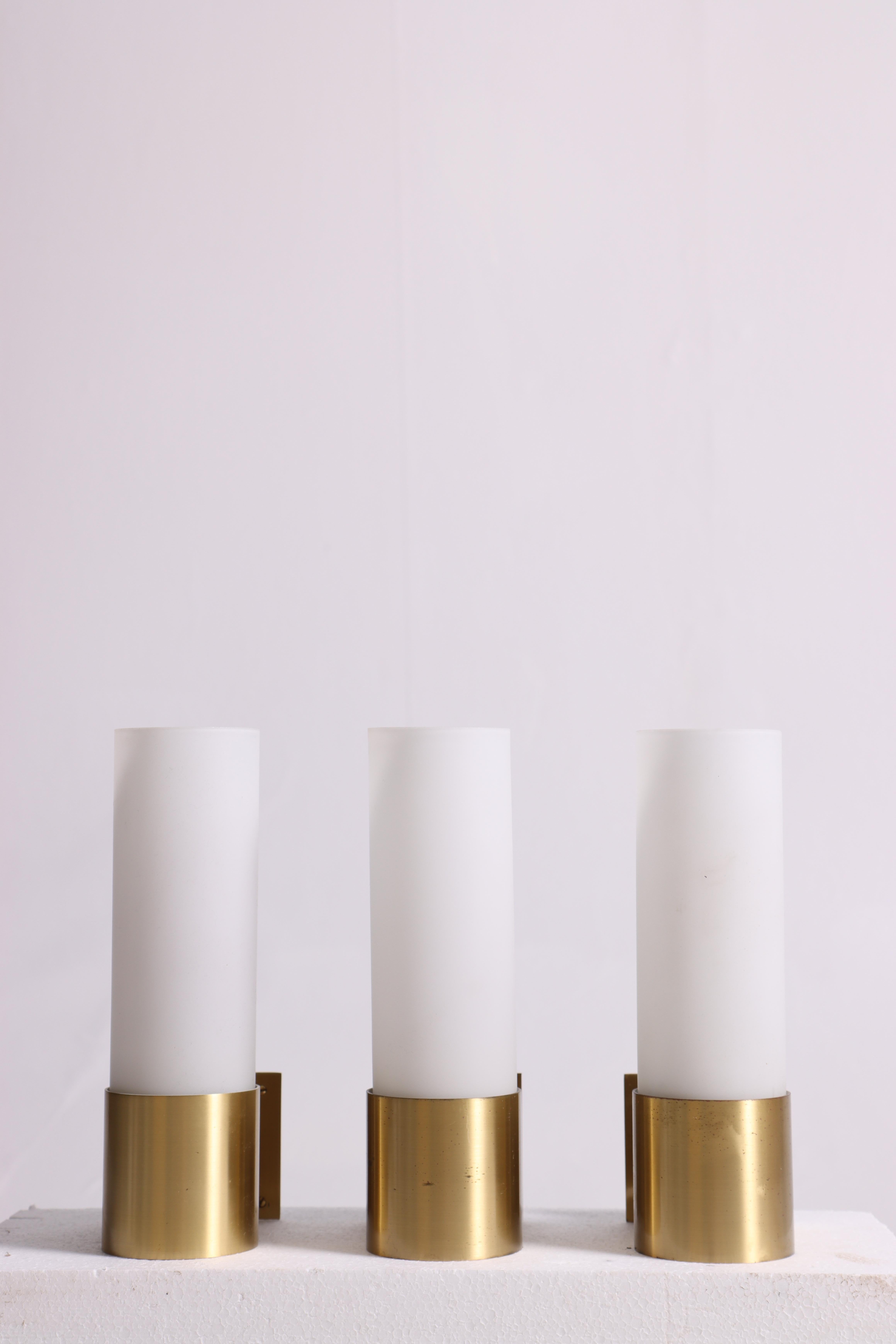 Set of three wall sconces in brass with glass shade. Designed by Jørgen Bo and made for Fog & Mørup. Great original condition.