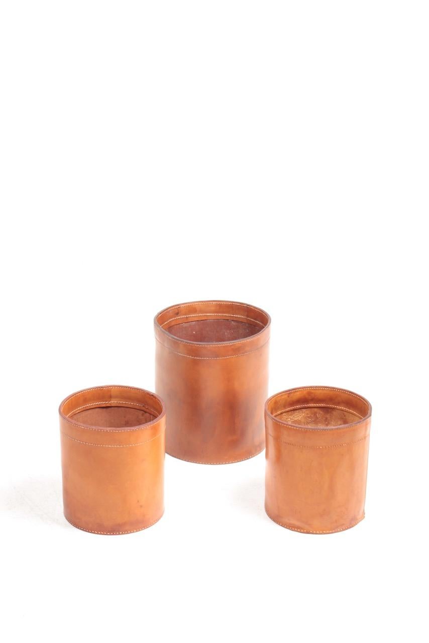 Set of three waste bins in various sizes made of patinated leather. Designed for Torben Oerskov Denmark in the 1960s great original condition.