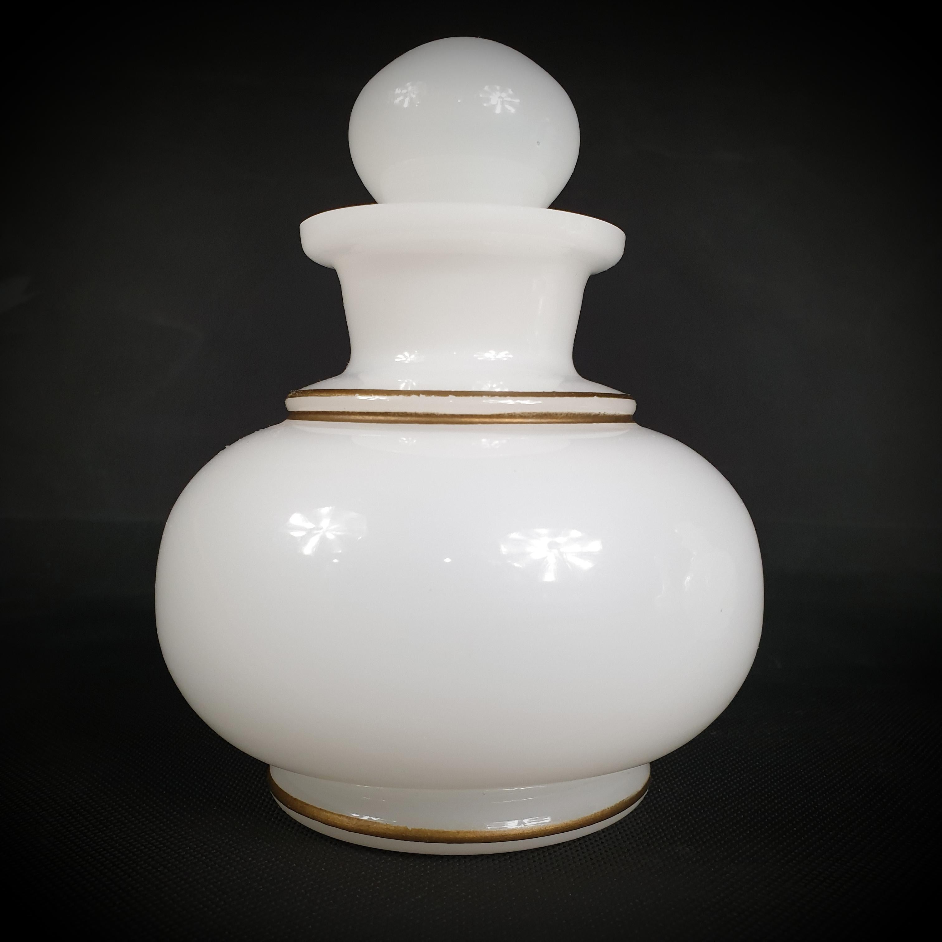 We are pleased to present a lovely trio of French opaline glass containers dating from between 1850 and 1900. The containers are spherical and translucent, and they feature a white, gilded finish. These works of art are a testament to the era's