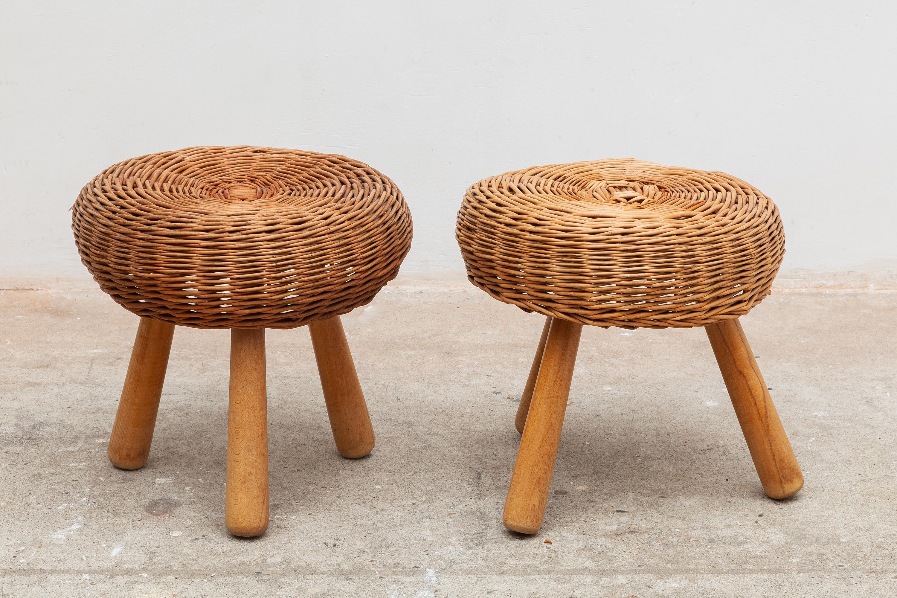 Vintage rattan stool set in the manner of Charlotte Perriand. One large and two small. Can be used as footstools, seating or tables. Tapered wooden legs. The legs can screw off.
Small: 33 W x 30 H cm Large: 47 W x 44 H cm.
  