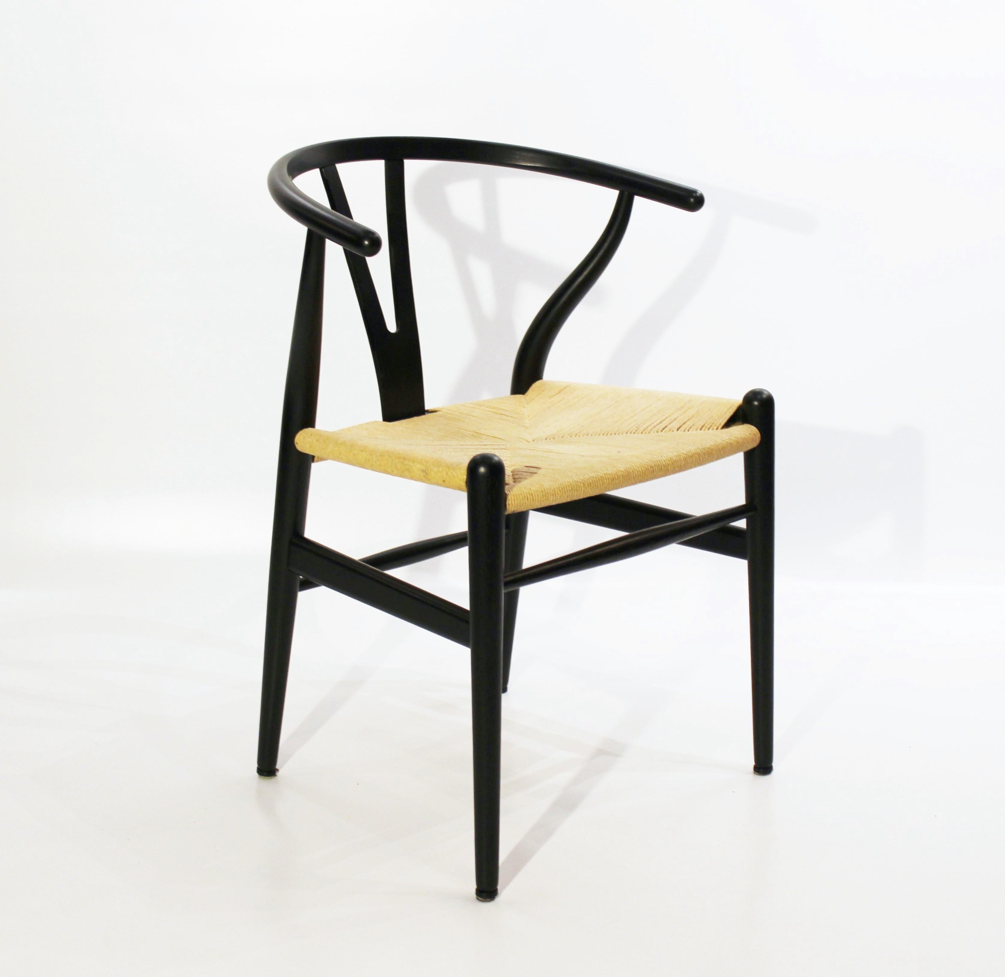 Set of three wishbone chairs, model CH24, of black painted wood and paper cord designed by Hans J. Wegner and manufactured by Carl Hansen & Son. The chairs are in great vintage condition.