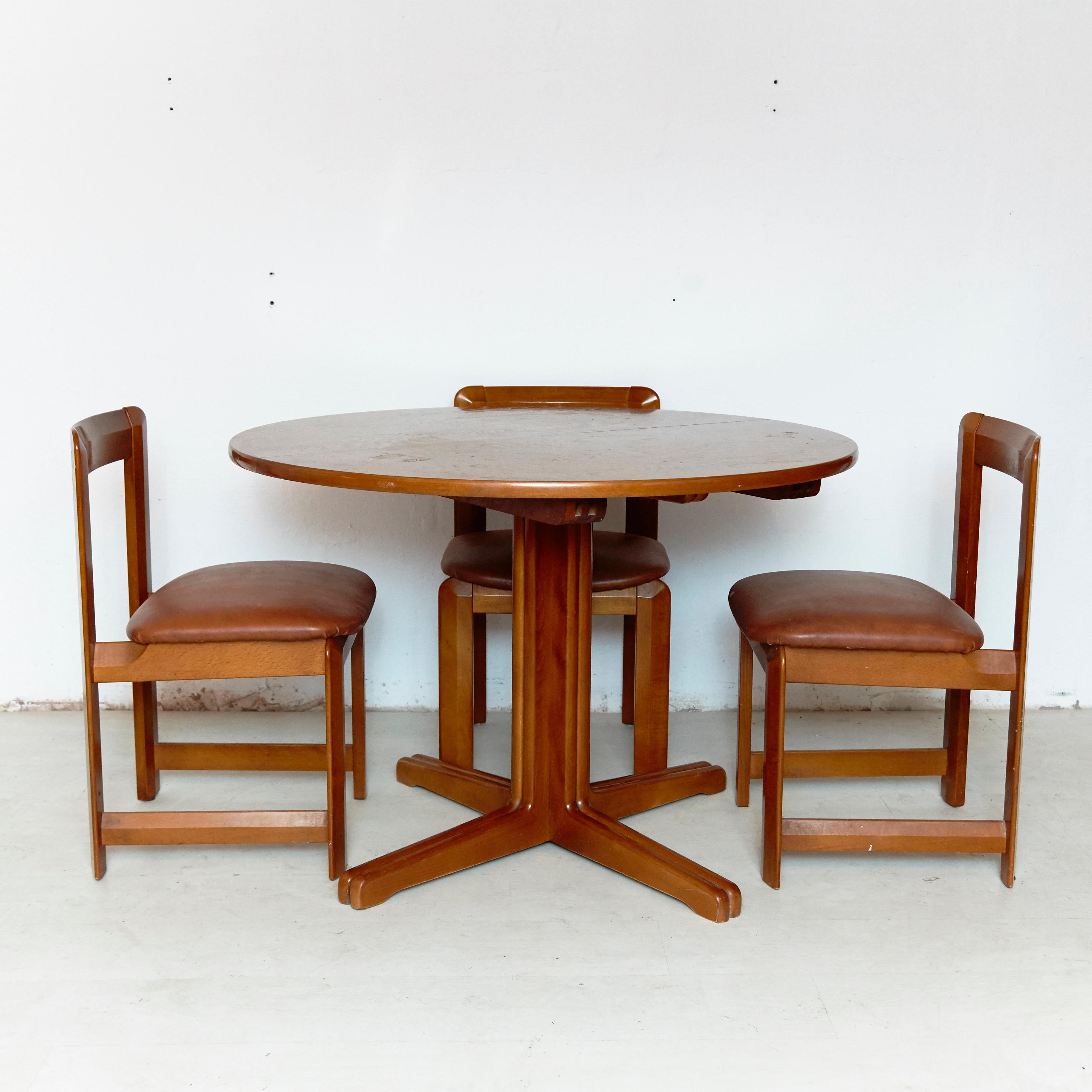 Set of three chairs and dining table.
Manufactured by Guillaumes (Spain), circa 1960.
Wood and skai.

In original condition with minor wear consistent of age and use, preserving a beautiful patina.

Table measurements:
H 75 cm x W 109 cm x D