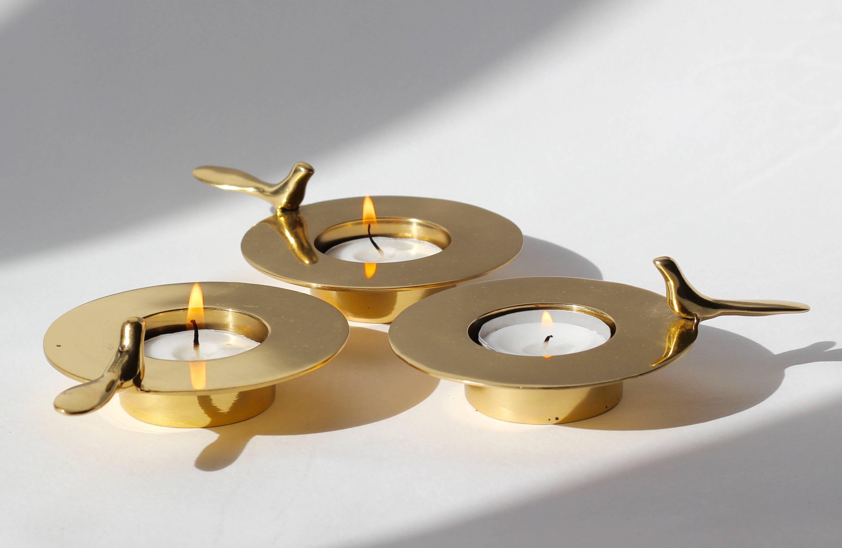 Set of three, each of those original and elegant brass T-light holders is handmade individually. Cast using very traditional techniques, they are polished revealing the lustrous finish of this beautiful material.

Those decorative elements are