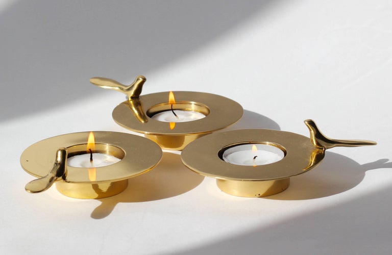 Set of three, each of those original and elegant brass T-light holders is handmade individually. Cast using very traditional techniques, they are polished revealing the lustrous finish of this beautiful material.

Those decorative elements are