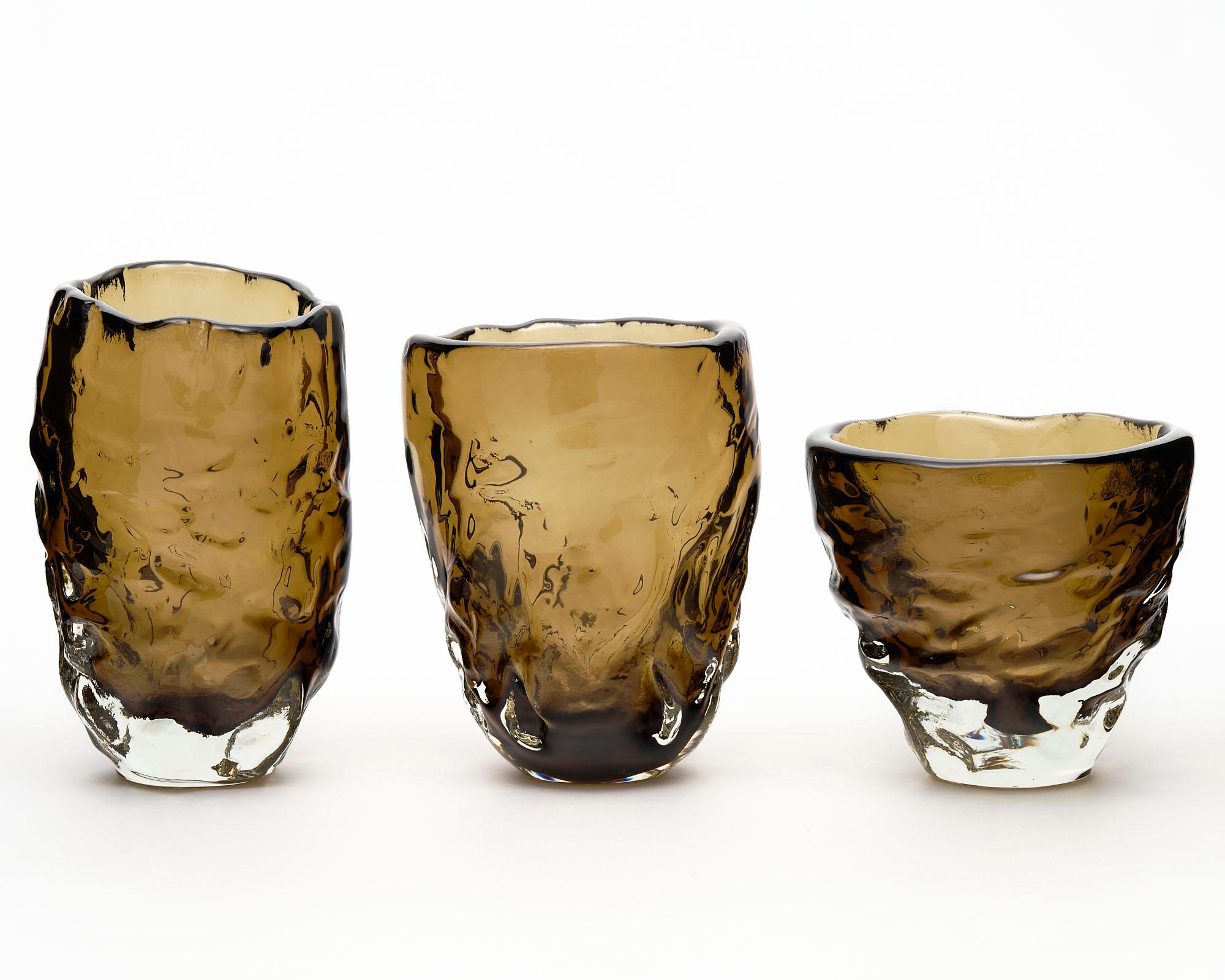 Set of three vases from the Island of Murano outside of Venice, Italy. They are hand blown in a tobacco color glass. The organic shape is an homage to Alberto Burri. Created by A. Donna. 

Measures: Large

Diameter: 8.25