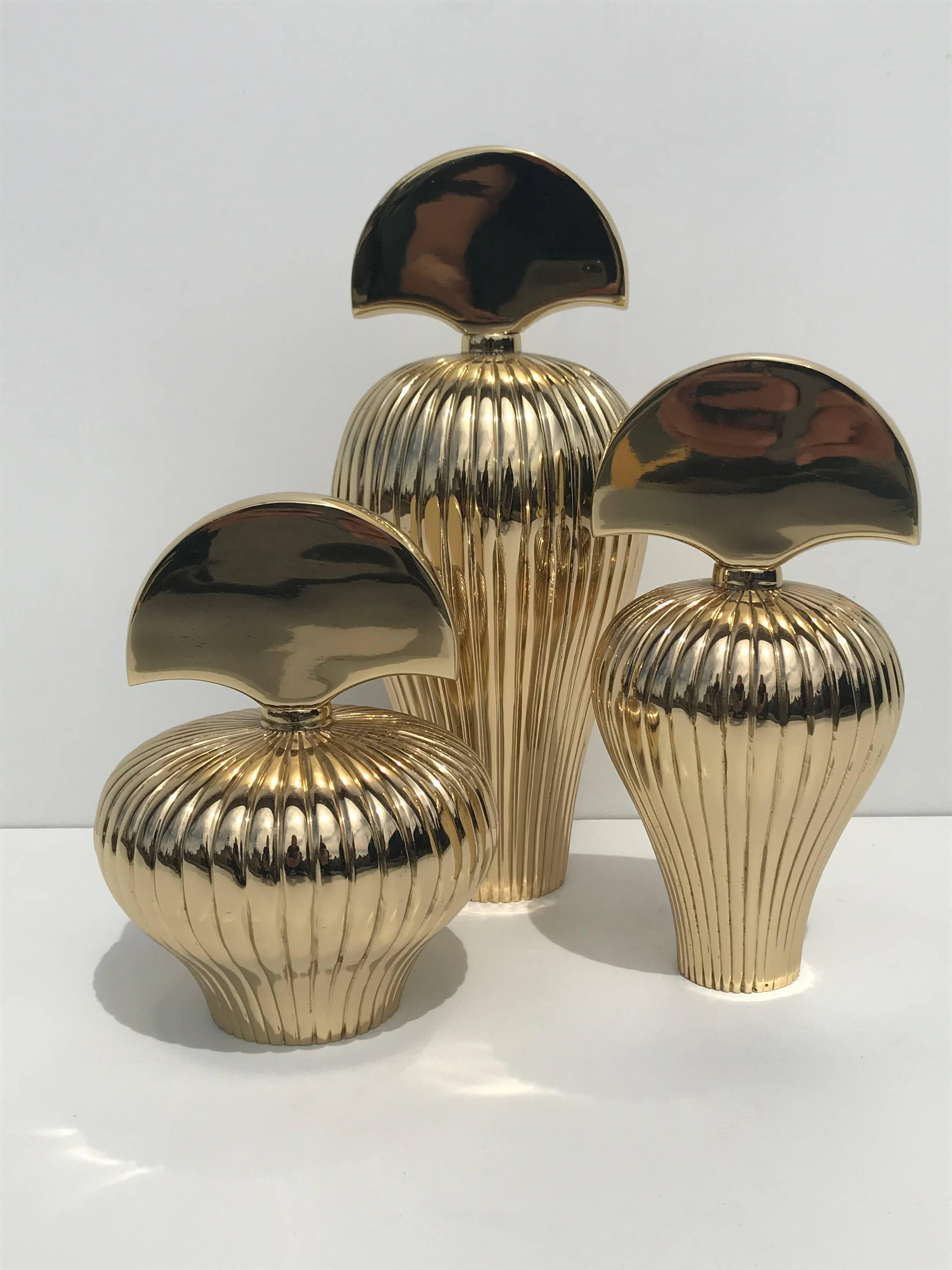 Set of three brass decorative perfume bottles. 
Measures: Large 13 inches
Medium 9.5 inches
Small 8 inches.

 
