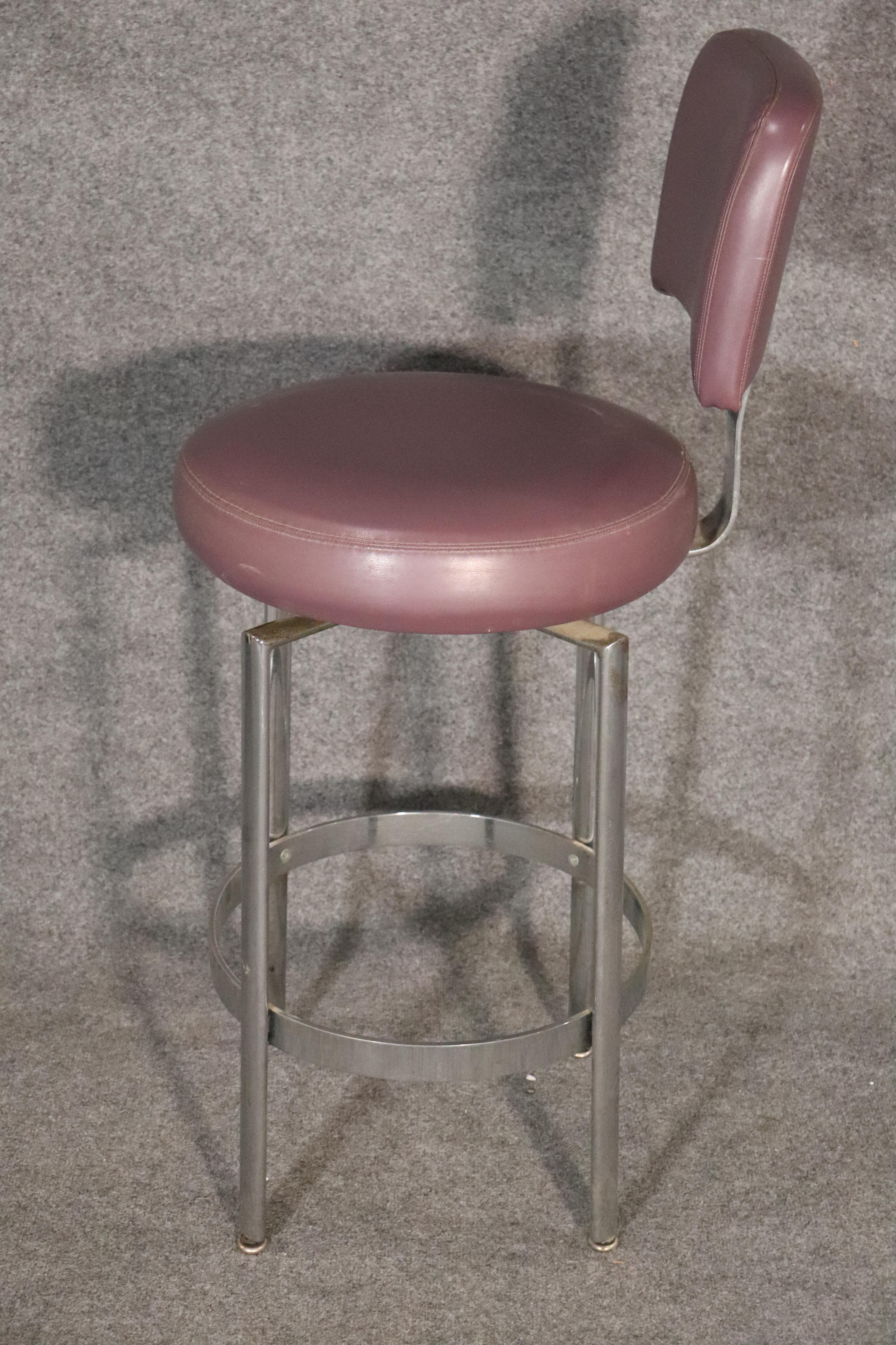 Four modern stools with polished chrome bases and purple faux leather seats and backs.
Please confirm location NY or NJ.