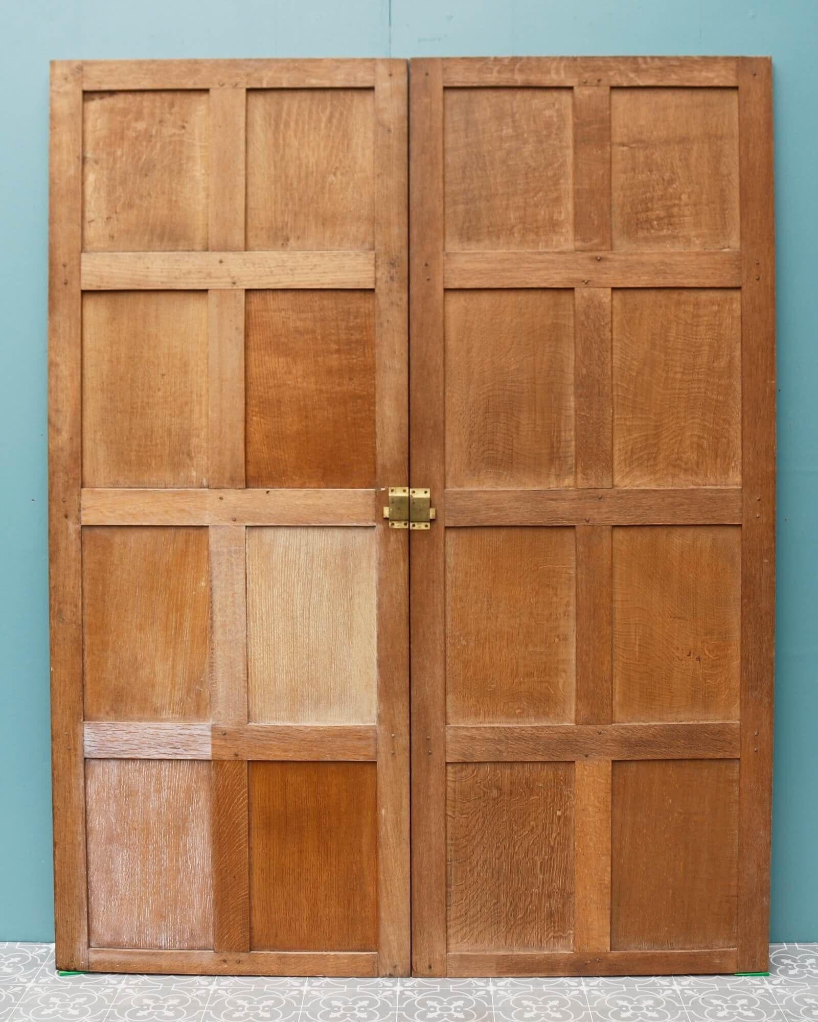 A set of Tudor style Victorian oak double doors sourced from a master bedroom in a large house in Windsor Park. These antique oak cupboard doors encompass a range of styles including Tudor, Jacobean, and Georgian. At over 130 years old, these doors