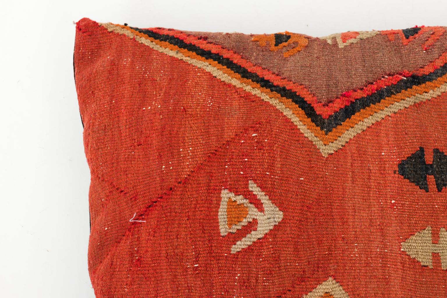 Set of four Turkish Kilim fabric pillows with Geometric detail, circa 20th century. Please note that the fabric has minor fading and repairs due to wear consistent with age.