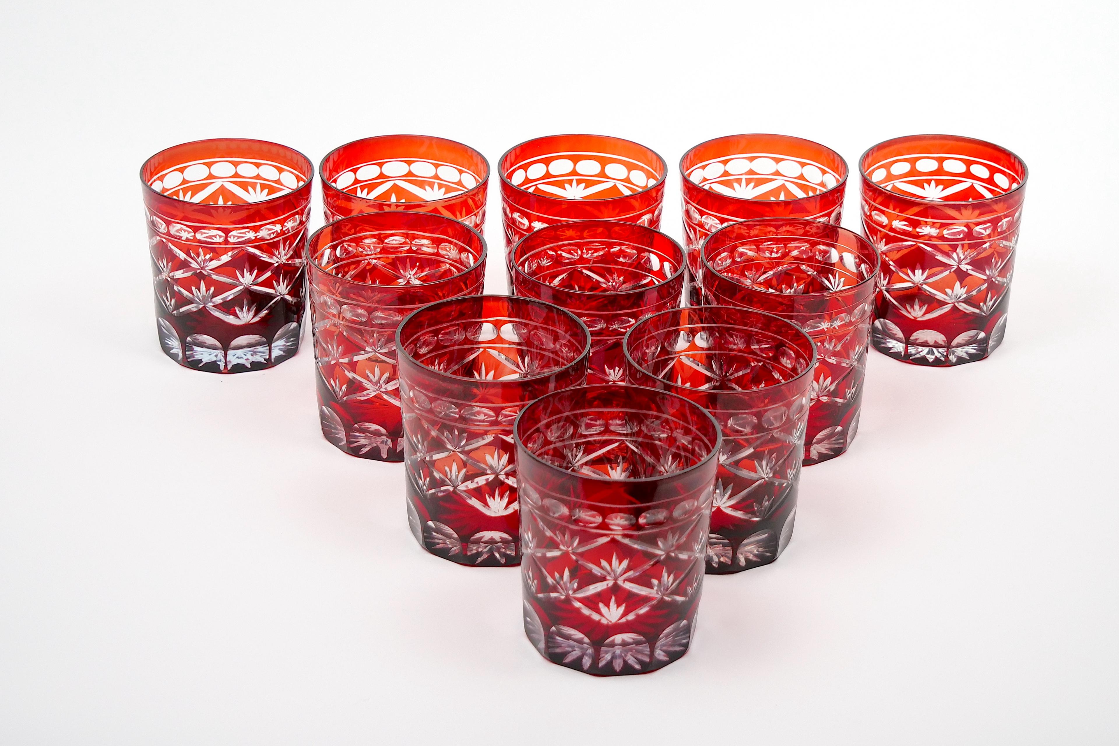 
Indulge in the opulent beauty of this early 20th century antique ruby red cut-to-clear barware / tableware rocks glassware service for twelve people. Each piece in this exquisite collection exudes timeless elegance and meticulous craftsmanship,