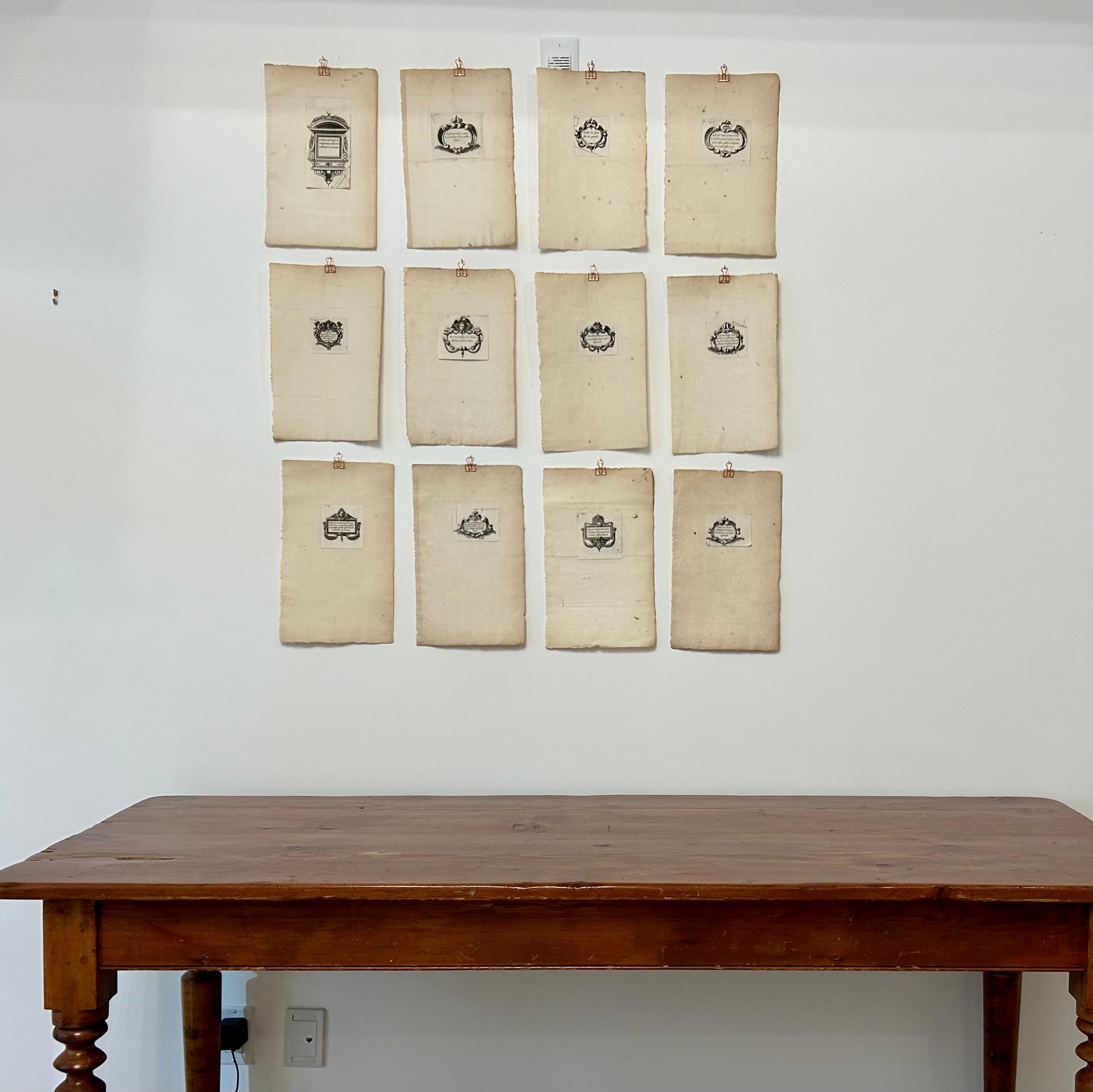 Set of twelve individual sheets with affixed printers' devices, each featuring individual designs along with wording in old french, dating from approximately 1700.
Printers' devices were created by the printers of books and engraved either on the