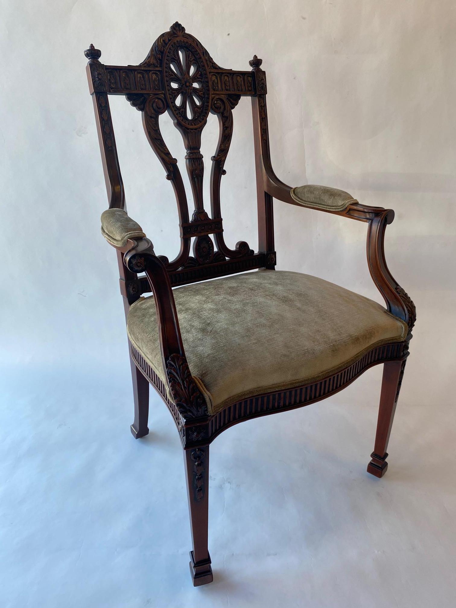 Set of Twelve 19th Century English Edwardian Mahogany Dining Chairs. Consisting of two armchairs and ten side chairs, highly carved, in the manner of Robert Adam (1728-1792).
Arm Chairs 25