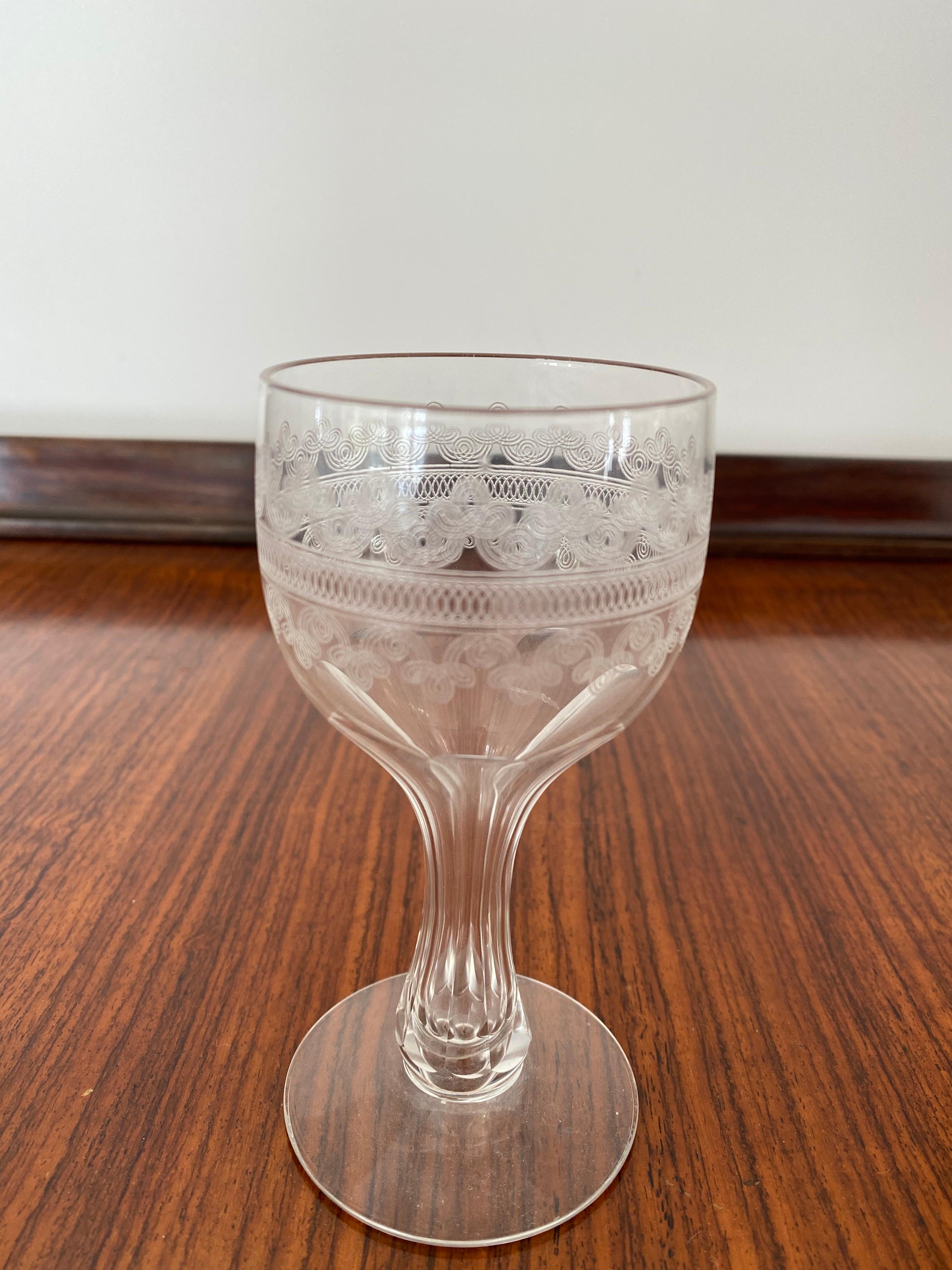 A set of twelve antique 19th century etched champagne or wine glasses with hollow stems.