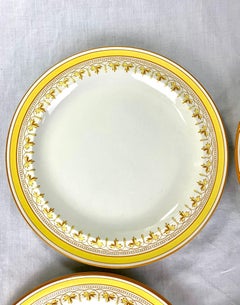 Juego de doce platos antiguos de Wedwood con bordes amarillos