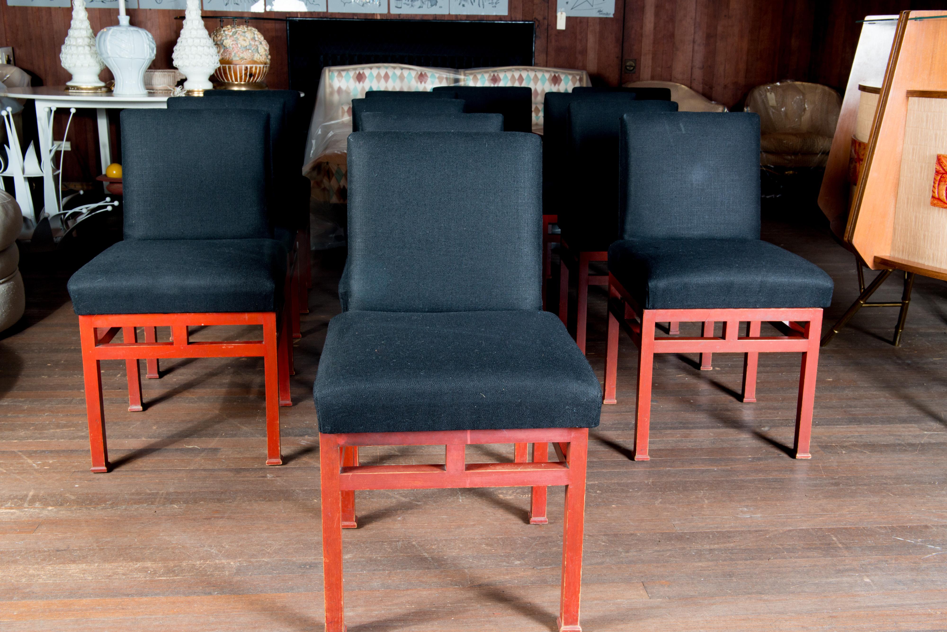 James Mont style set of 12 Moderne red lacquered wood dining chairs with black upholstery. Two arm chairs and ten side chairs. Dating from the 1940s. Midcentury Modern. Original red painted finish. Arm chair: 22.5 wide, 21 deep, 32.5 high, 19 seat