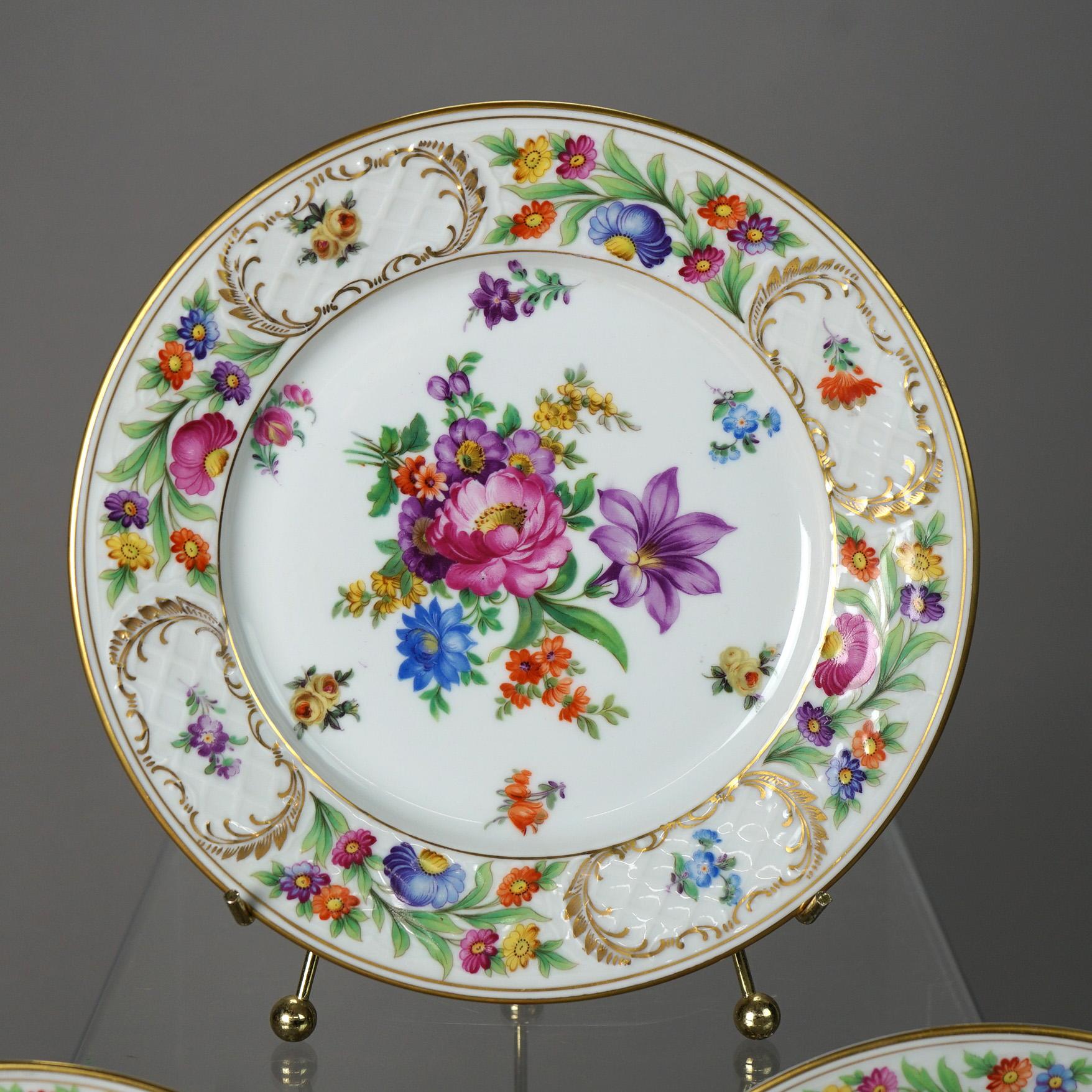 A set of twelve luncheon plates by Schumann offer bone china construction with garden flowers, maker mark on base as photographed, 20th century

Measures  - 1