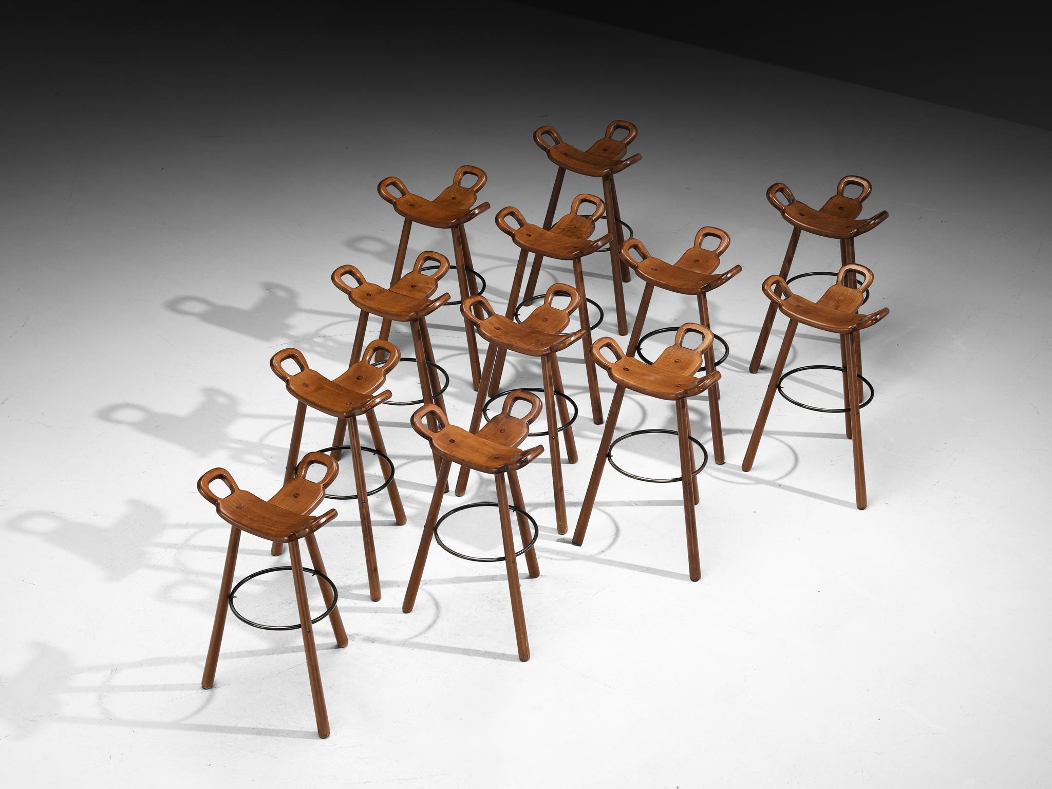 Set of twelve barstools, stained beech, lacquered steel, Europe, 1970s

Seventies Brutalist-inspired bar stools that exhibit a distinctive, sculptural approach with a brutalist touch to seating design. The saddle-shaped seats, carved with a gentle
