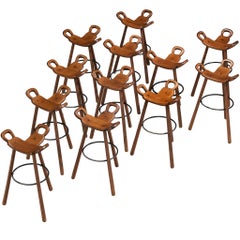 Set of Twelve Brutalist Bar Stools in Dark Wood