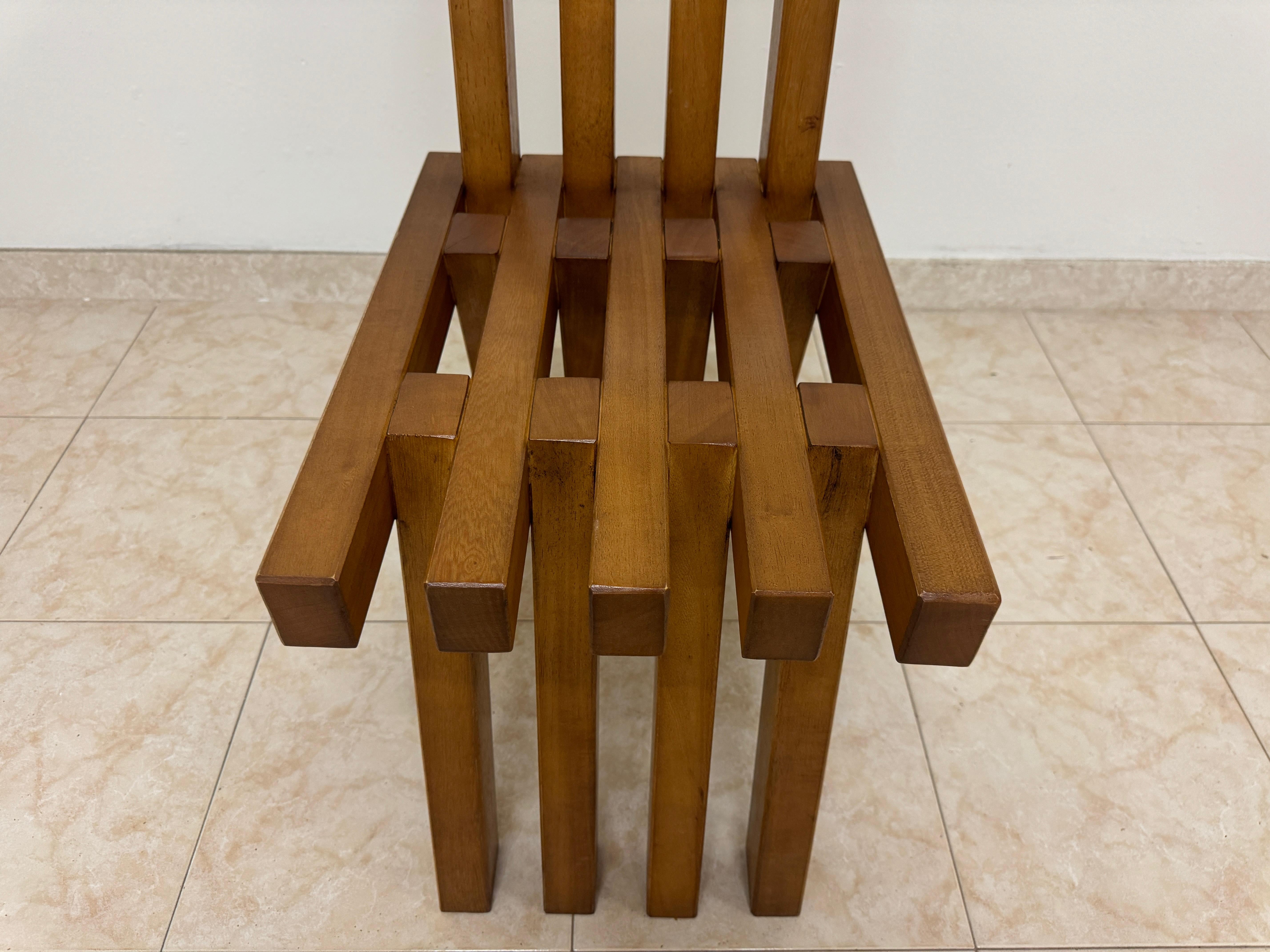 Un grande set di dodici sedie da pranzo, caratterizzate da un design brutalista unico e distinto. Queste sedie sono costruite in legno e hanno un aspetto pesante e robusto. Il design è caratterizzato dalle seguenti caratteristiche:

Ogni sedia ha