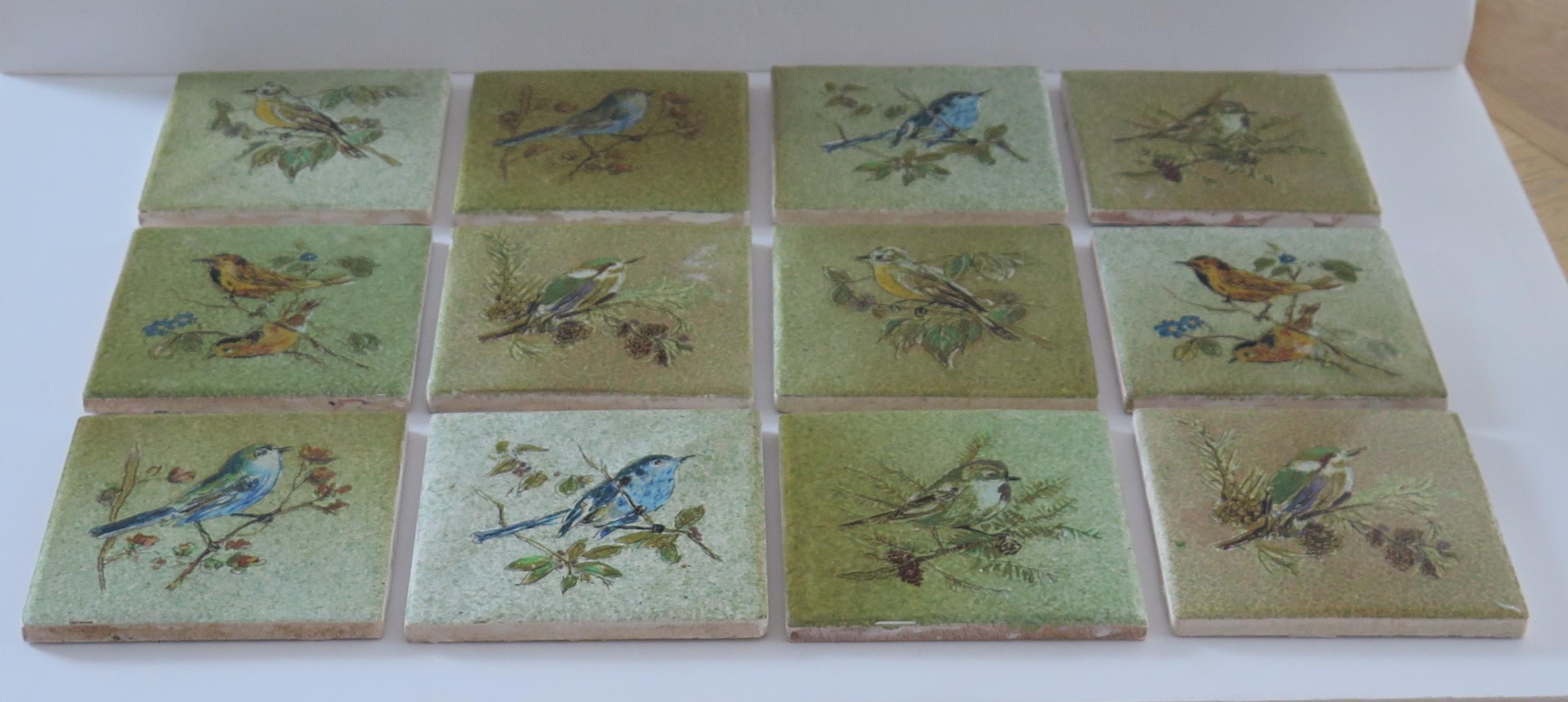 These are a good set of twelve glazed ceramic wall tiles, hand enamelled with a bird theme, probably over an underglaze printed outline and dating to the mid-20th century, circa 1930. 

Each tile is nominally 4.25 inches ( 11cm) square. There are