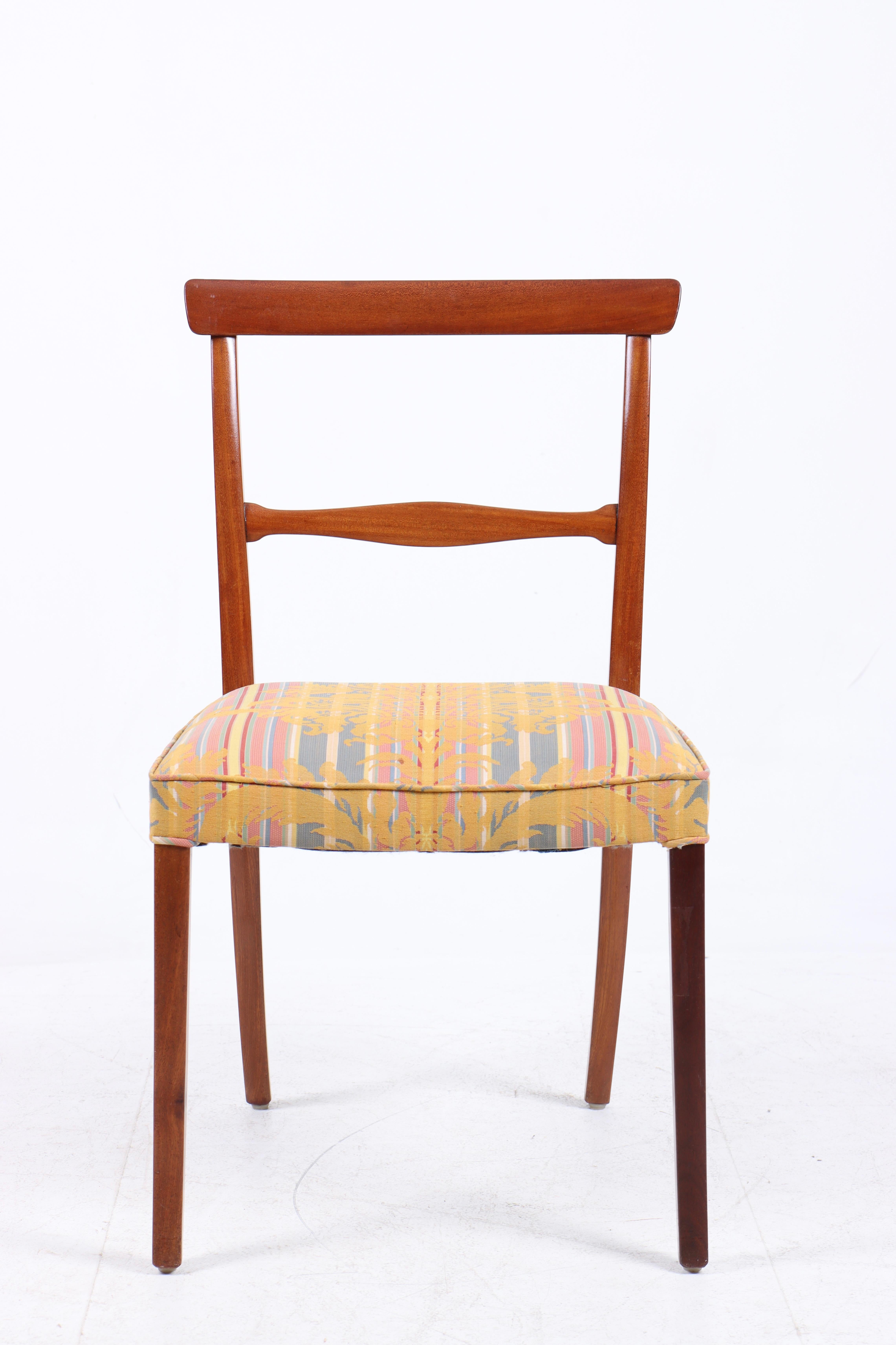 Set of 12 mahogany chairs with curvy, horizontal bar in back. Seat upholstered with patterned fabric. Designed 1962. These examples made 1962–1970s by cabinetmaker A.J. Iversen, with maker's label. (12)
Literature: Noritsugu Oda: “Danish Chairs”,